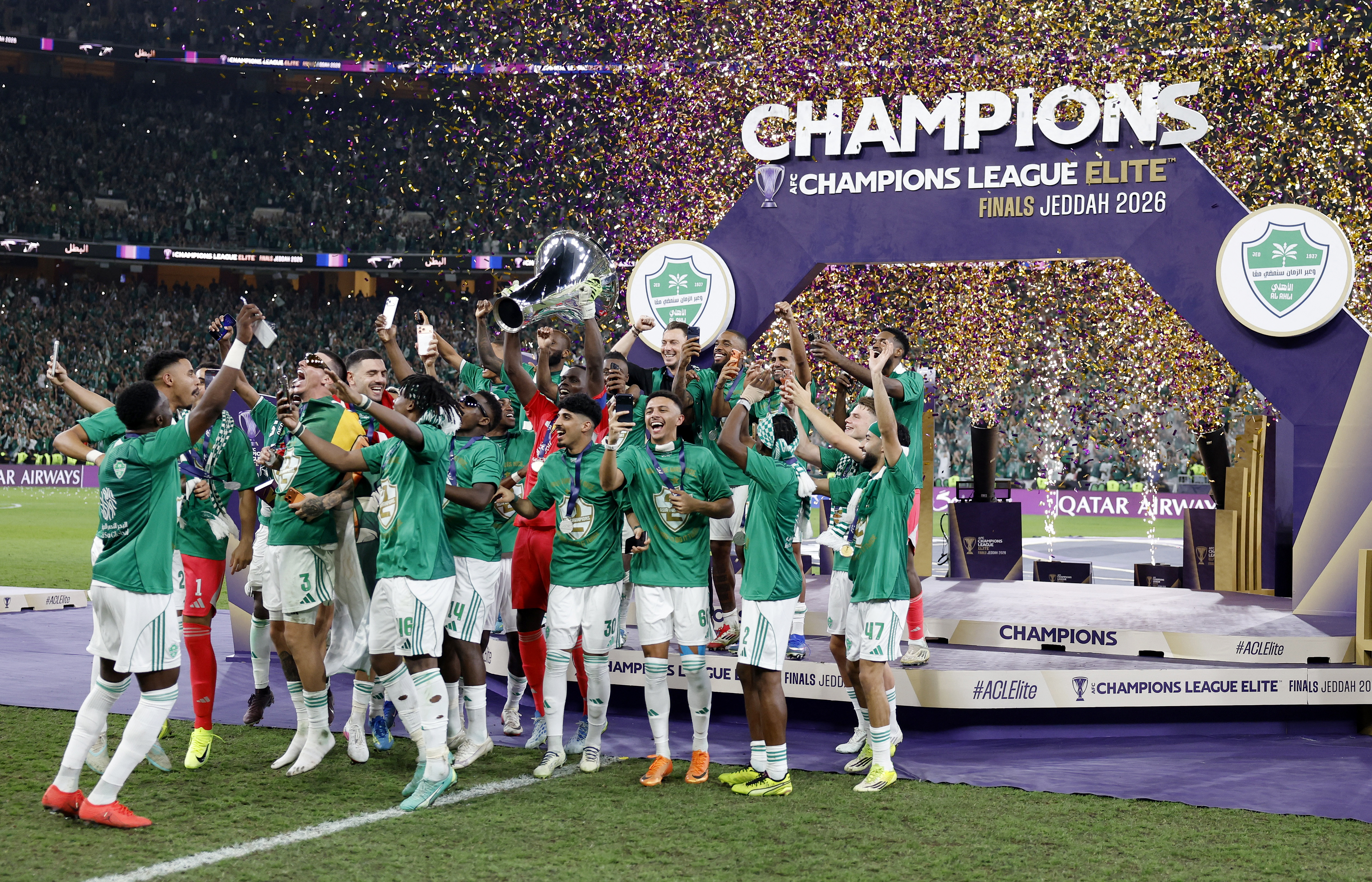 Al Ahli players celebrate with the trophy after winning the Asian Champions League