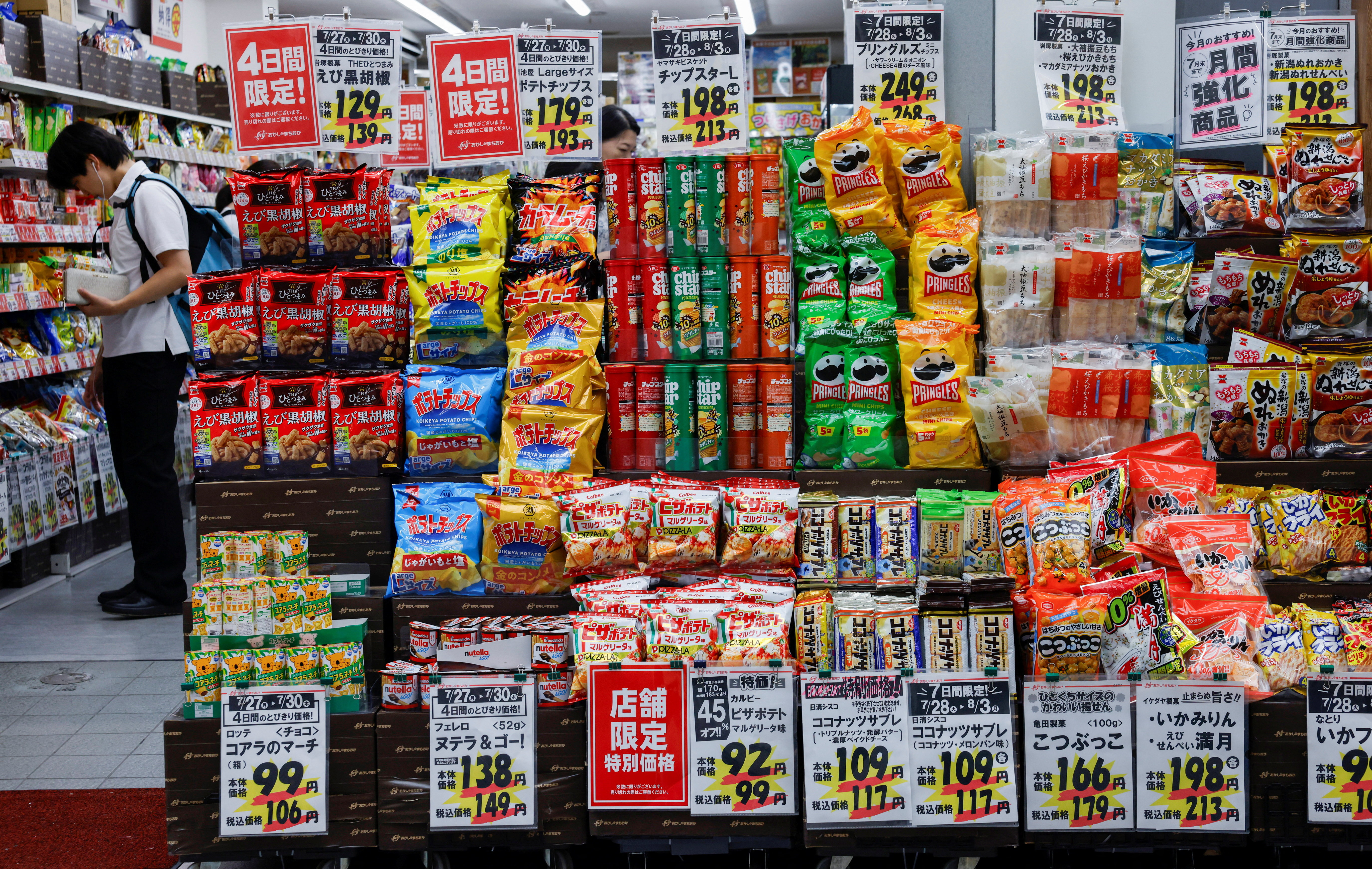 People shop for snacks at a confectionery store in Tokyo, Japan on July 28, 2026. [Manami Yamada/Reuters]