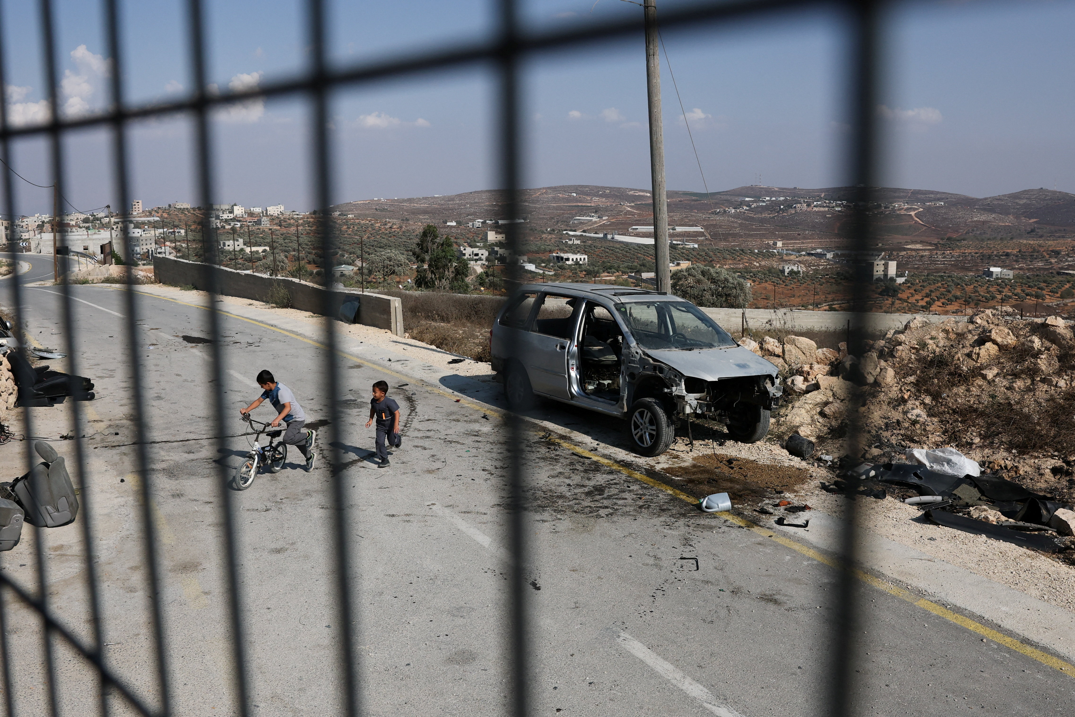 Palestinian children play in the street on the outskirts of Qusra, a Palestinian village in the occupied West Bank