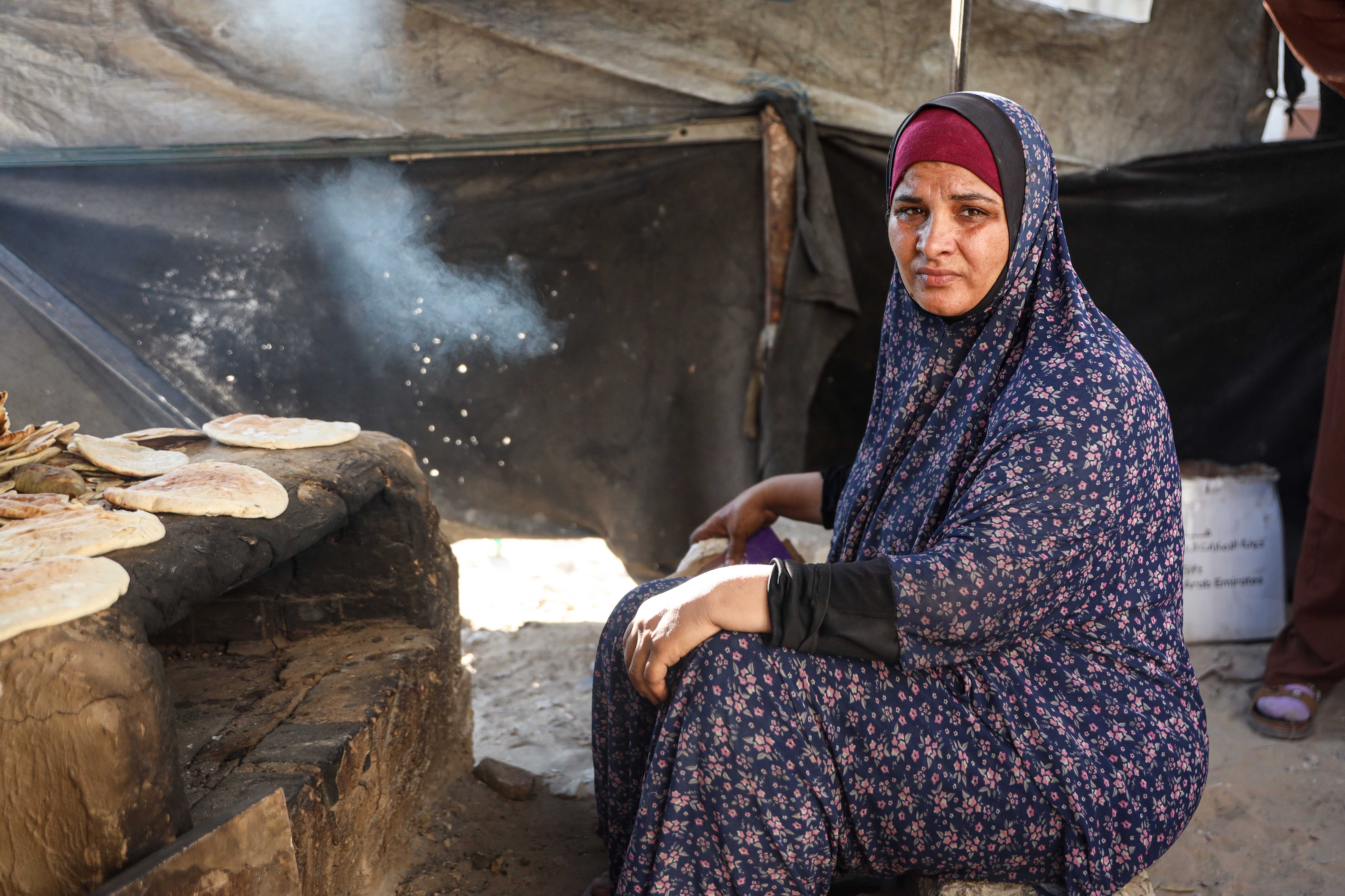 Rabab Deifallah says she has sometimes gone two or three days without lighting a fire because she could not find a lighter [Abdelhakim Abu Riash/ Al Jazeera]