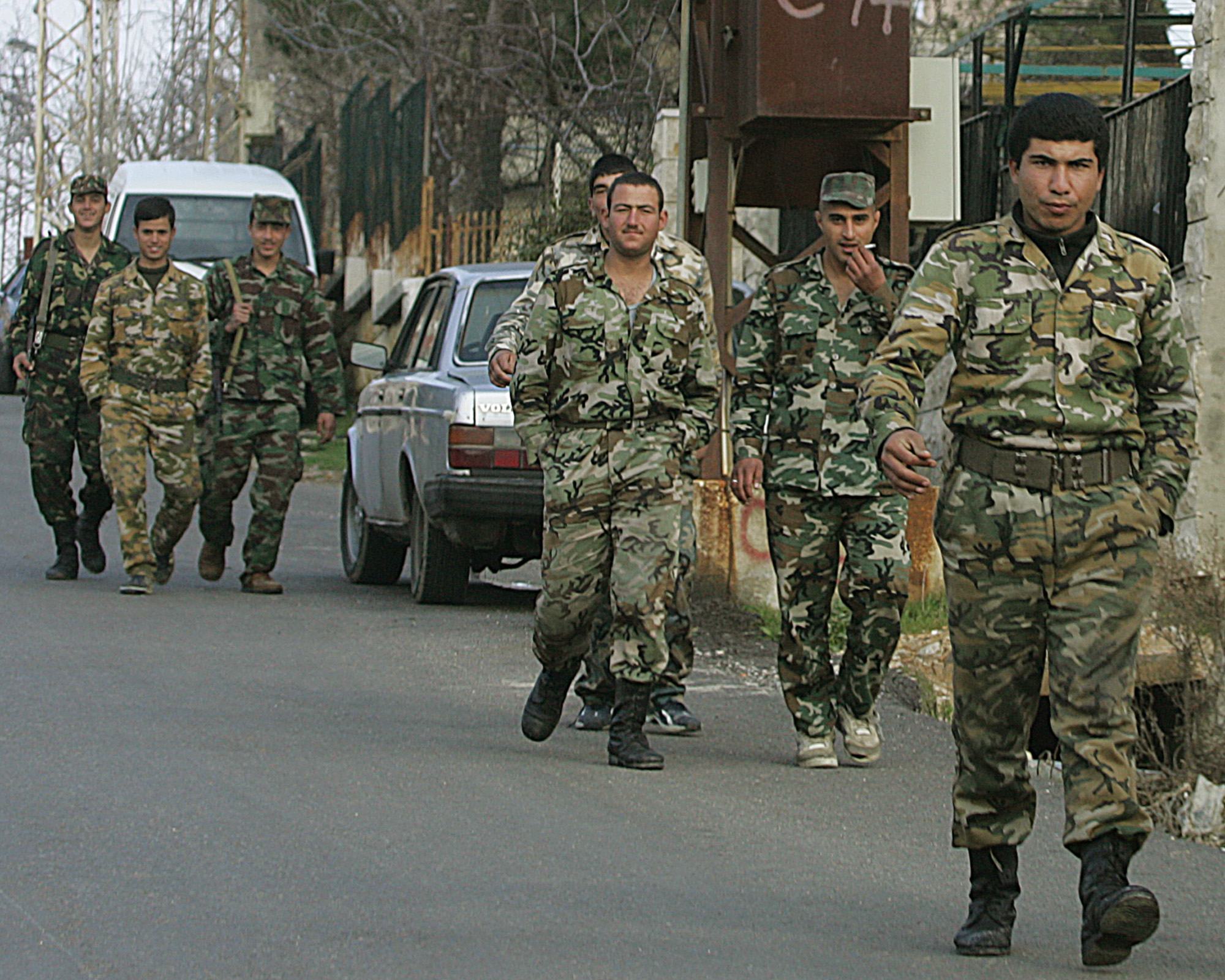 Syrian soldiers walk along a street in the hills above the mountain resort of Aley, Lebanon, Friday Feb. 25, 2005. Syrian soldiers stationed in the mountains overlooking Beirut and in northern regions went about their daily chores Friday, exercising, manning posts and even doing laundry one day after announcements that Syrian forces would begin to withdraw eastward to areas close to the Syrian border. (AP Photo/Hussein Malla)