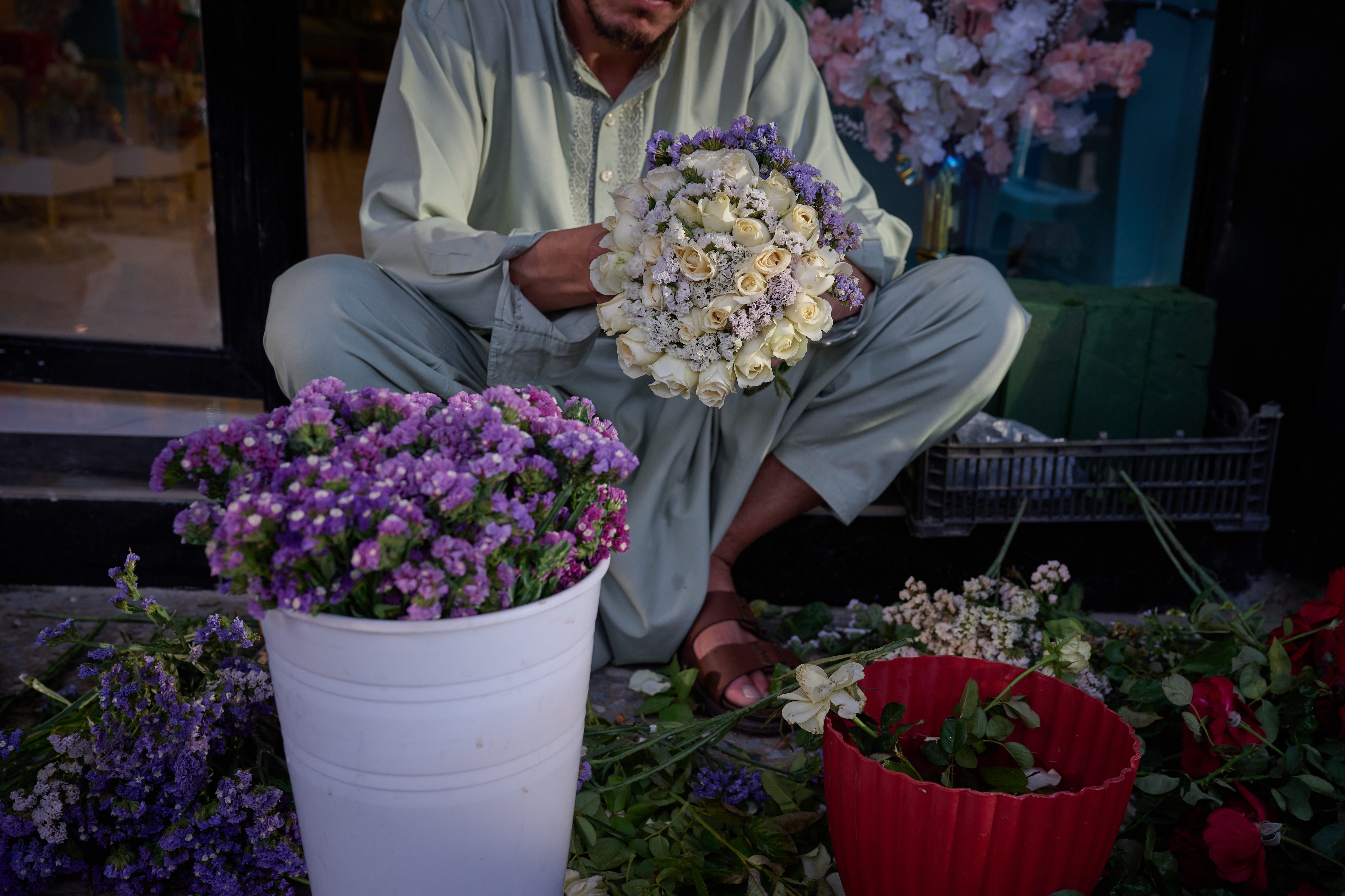 A flower seller arranges bouquets ahead of celebrations marking the fifth anniversary of the U.S. withdrawal