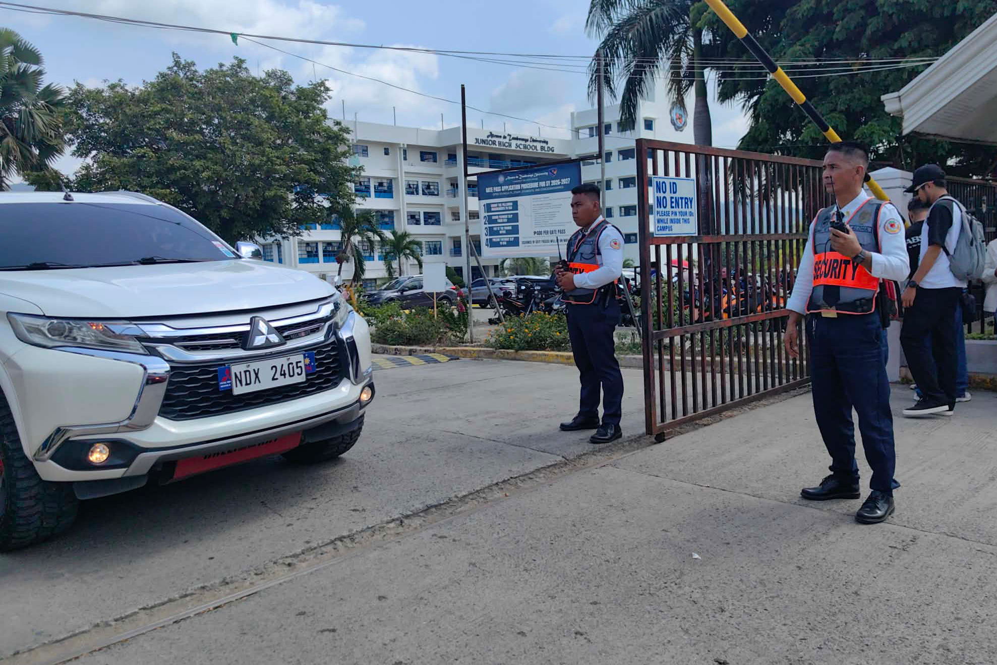 Security guards keep watch as vehicles exit the Ateneo de Zamboanga University