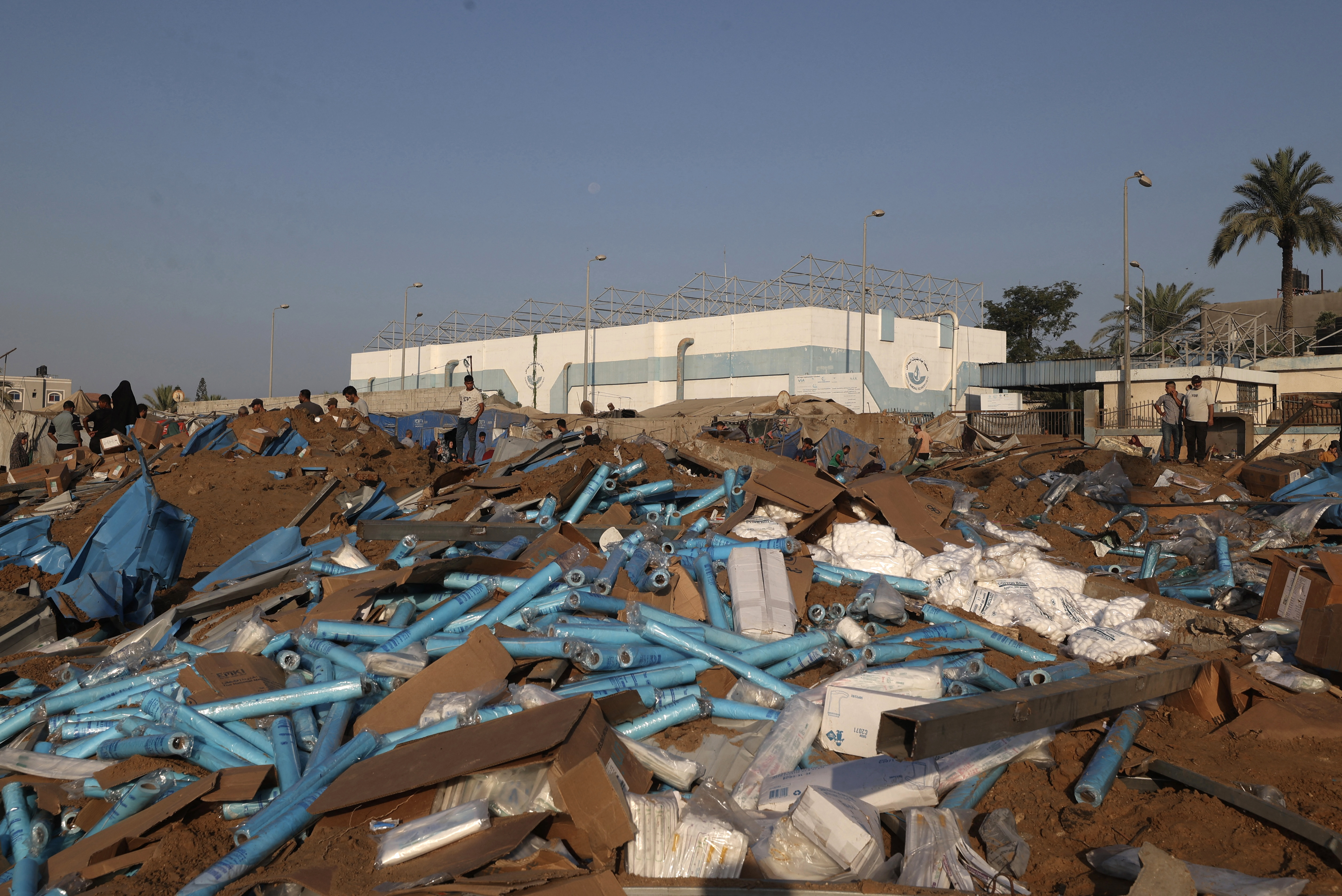 Displaced Palestinians inspect the destruction following an Israeli airstrike that targeted the nearby medical supplies and pharmaceuticals warehouse of Al-Aqsa Martyrs Hospital, in Deir al-Balah, central Gaza Strip on August 1, 2026.
