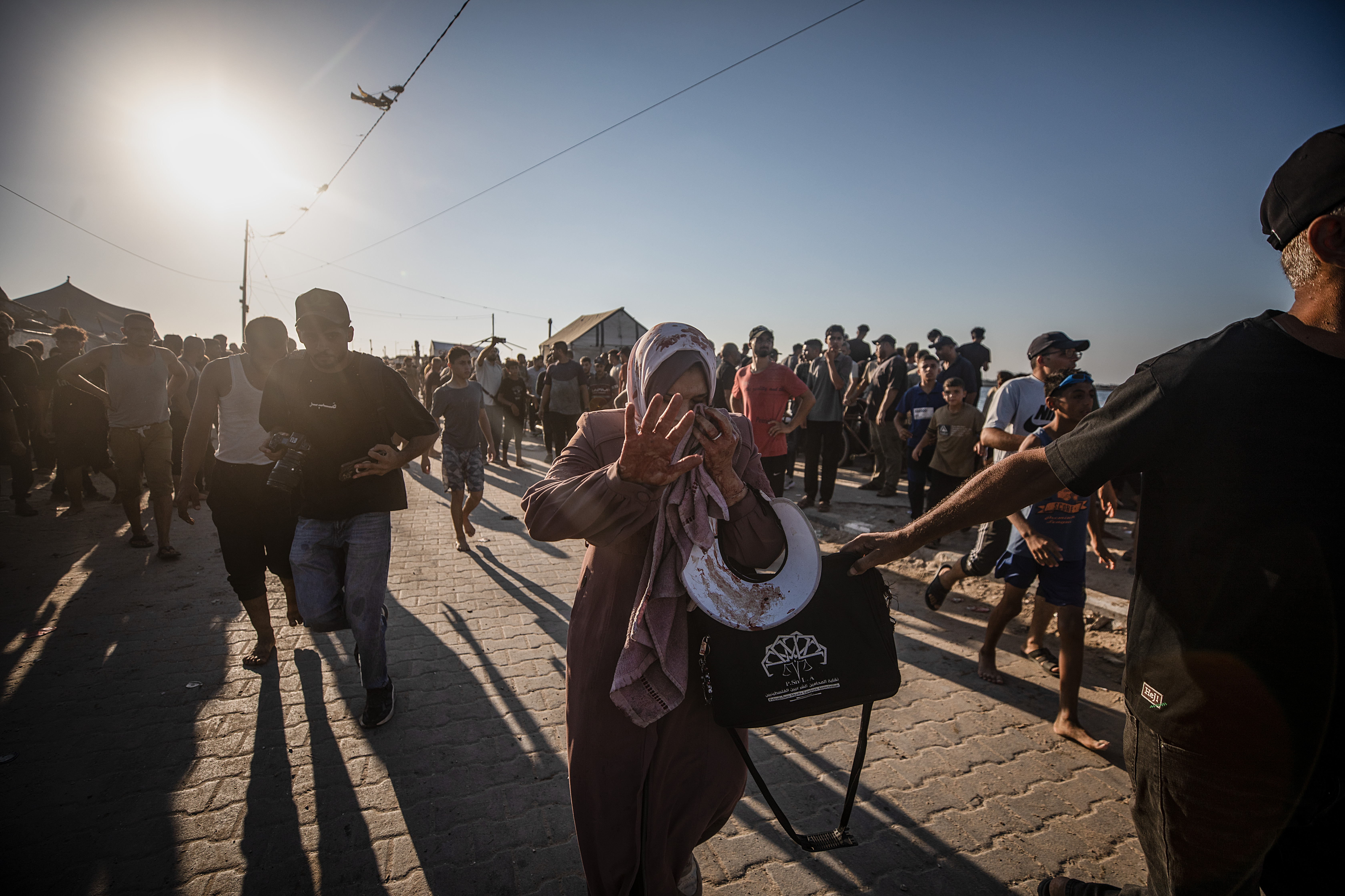 epa13177538 An injured Palestinian woman following an Israeli airstrike at Gaza port near the beach in Gaza City, 18 August 2026. The Ministry of Health in Gaza said at least six Palestinians were killed and others injured in an Israeli airstrike in western Gaza City. EPA/MOHAMMED SABER