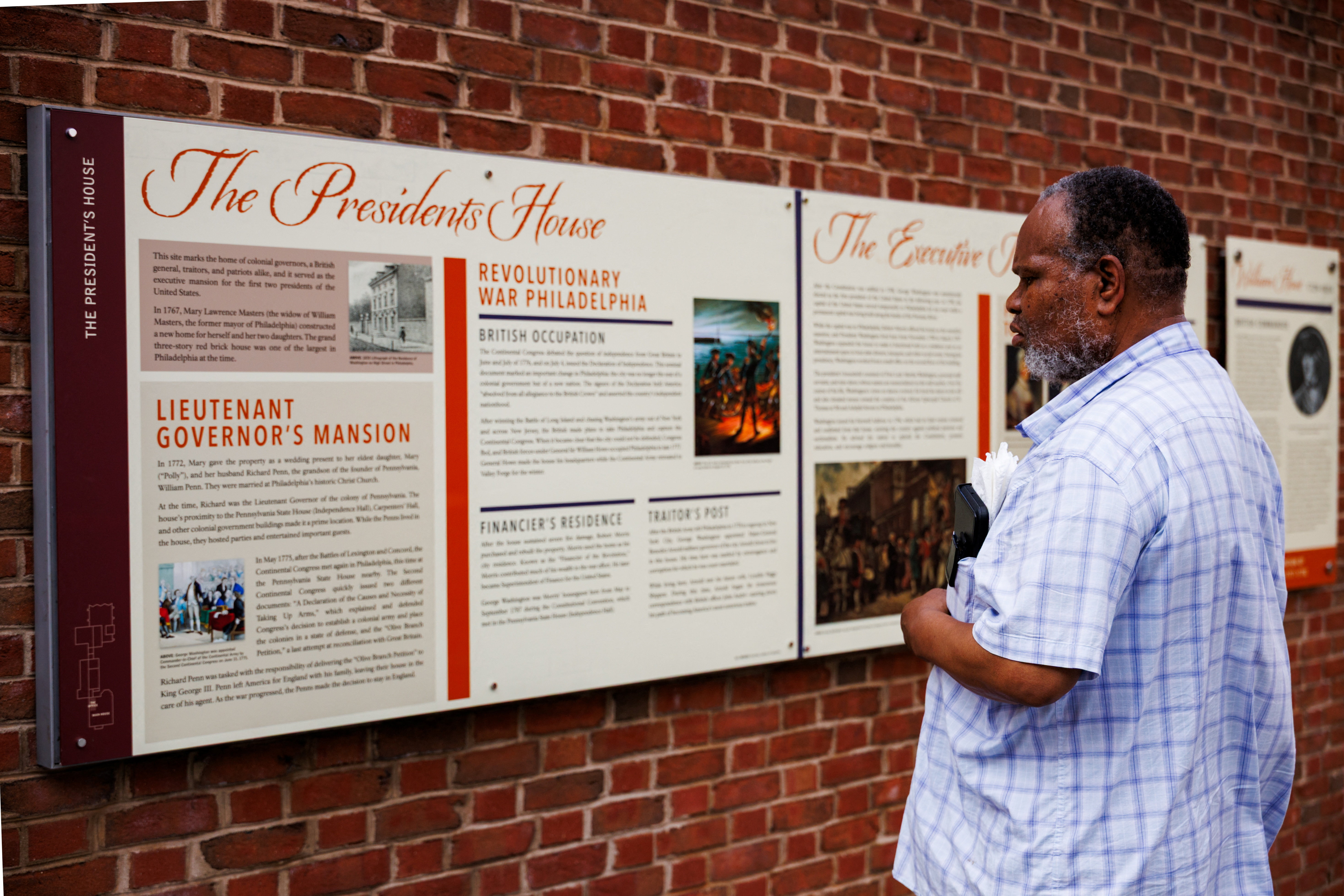 Iday A. Muhammad looks on at the President's House Site panels after U.S. President Donald Trump's administration installed new information panels on slavery following a federal appeals court ruling that opened the way to ‌changing how slavery is portrayed at the national historical site, in Philadelphia, Pennsylvania, U.S., July 15, 2026. REUTERS/Hannah Beier