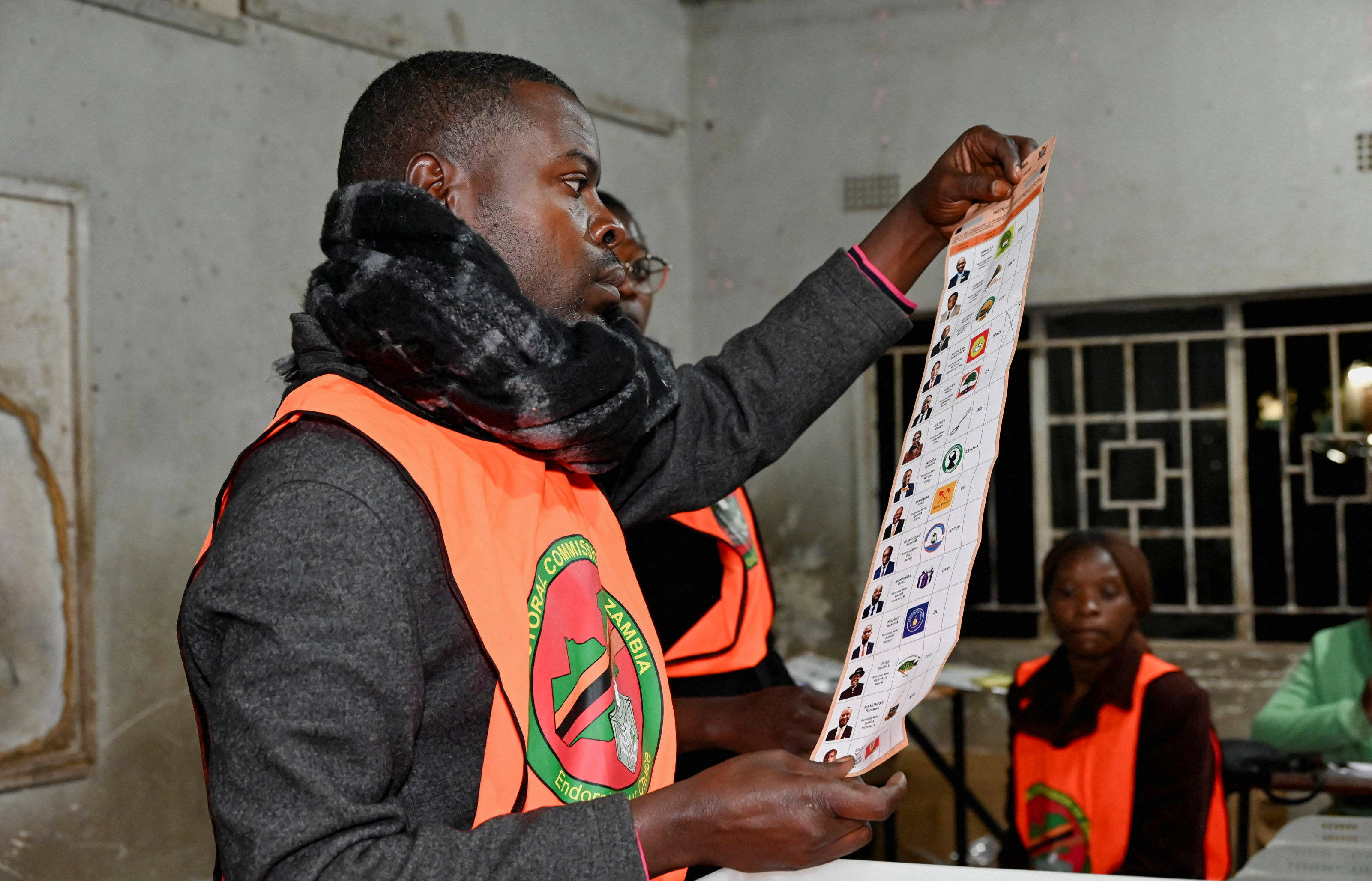 Election officials display a ballot paper while sorting and counting votes after polls close at a polling station during Zambia's general elections, including the presidential election, in Lusaka, Zambia, August 13, 2026. REUTERS/Moses Mwape