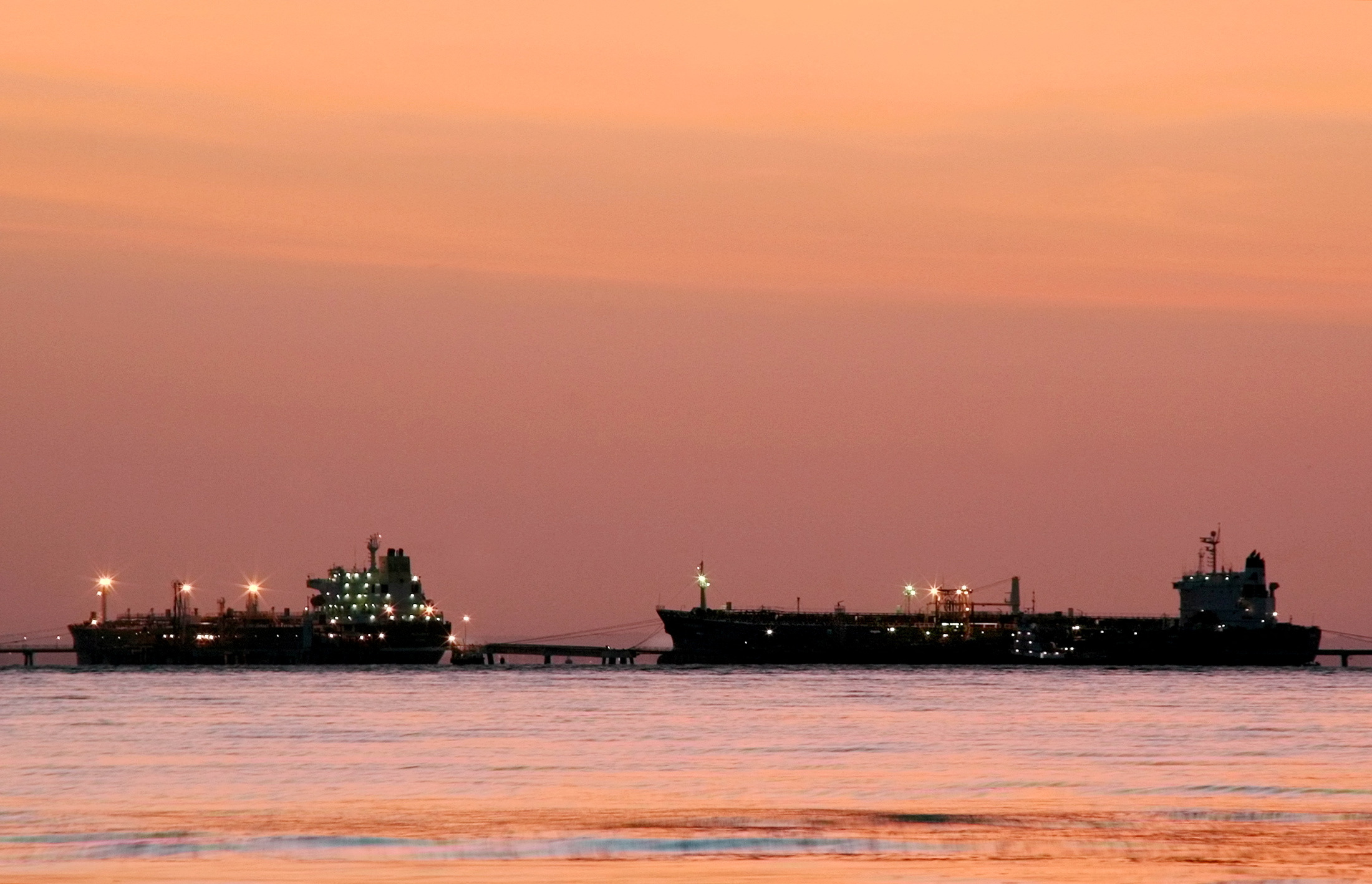 FILE PHOTO: Oil tankers are seen at daybreak at the Bajo Grande Terminal located on the western shore of Lake Maracaibo, south of the city of Maracaibo, Venezuela August 23, 2005. REUTERS/Raquel Chavez JS/KS/File Photo