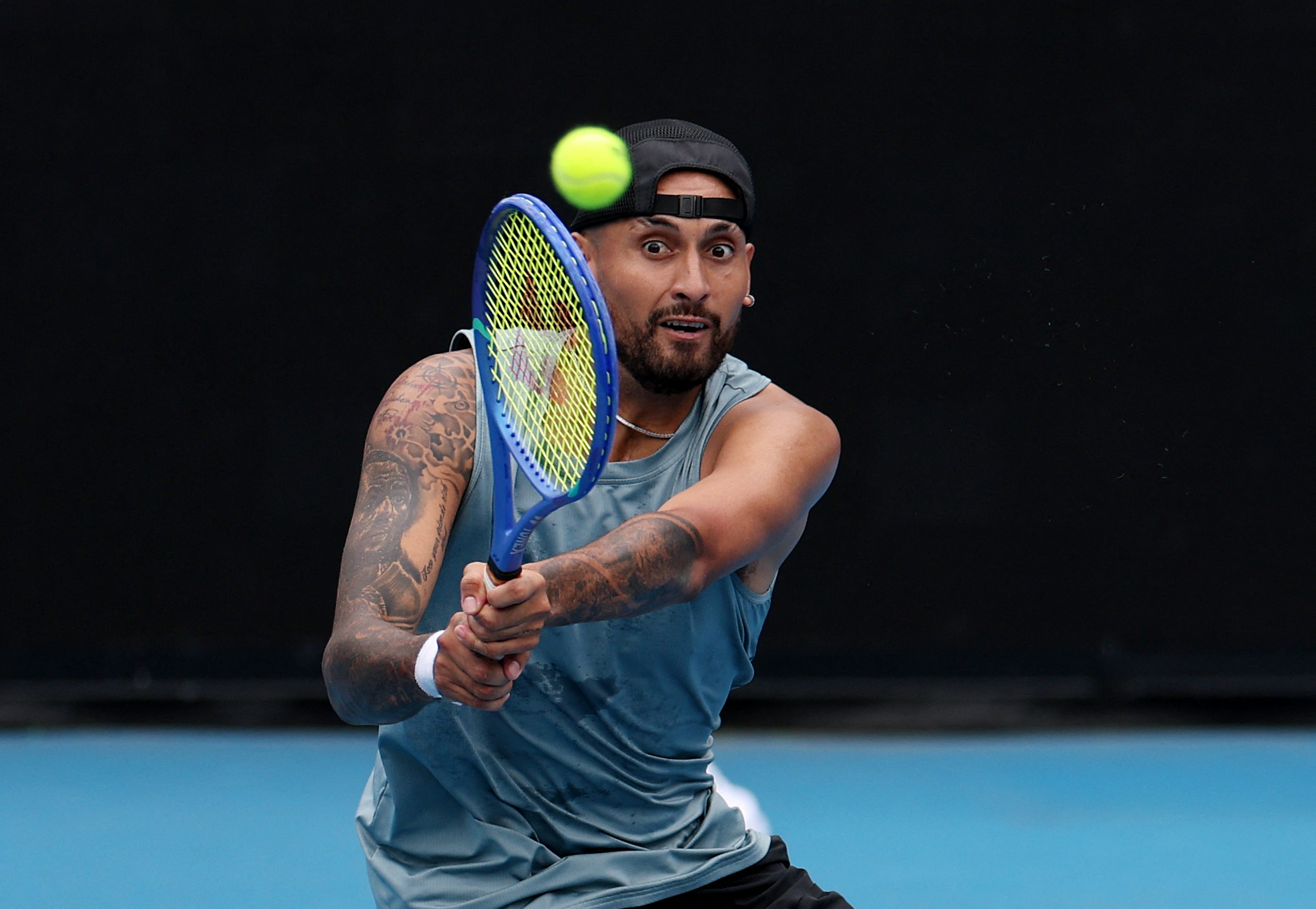 A tennis player swings his racket