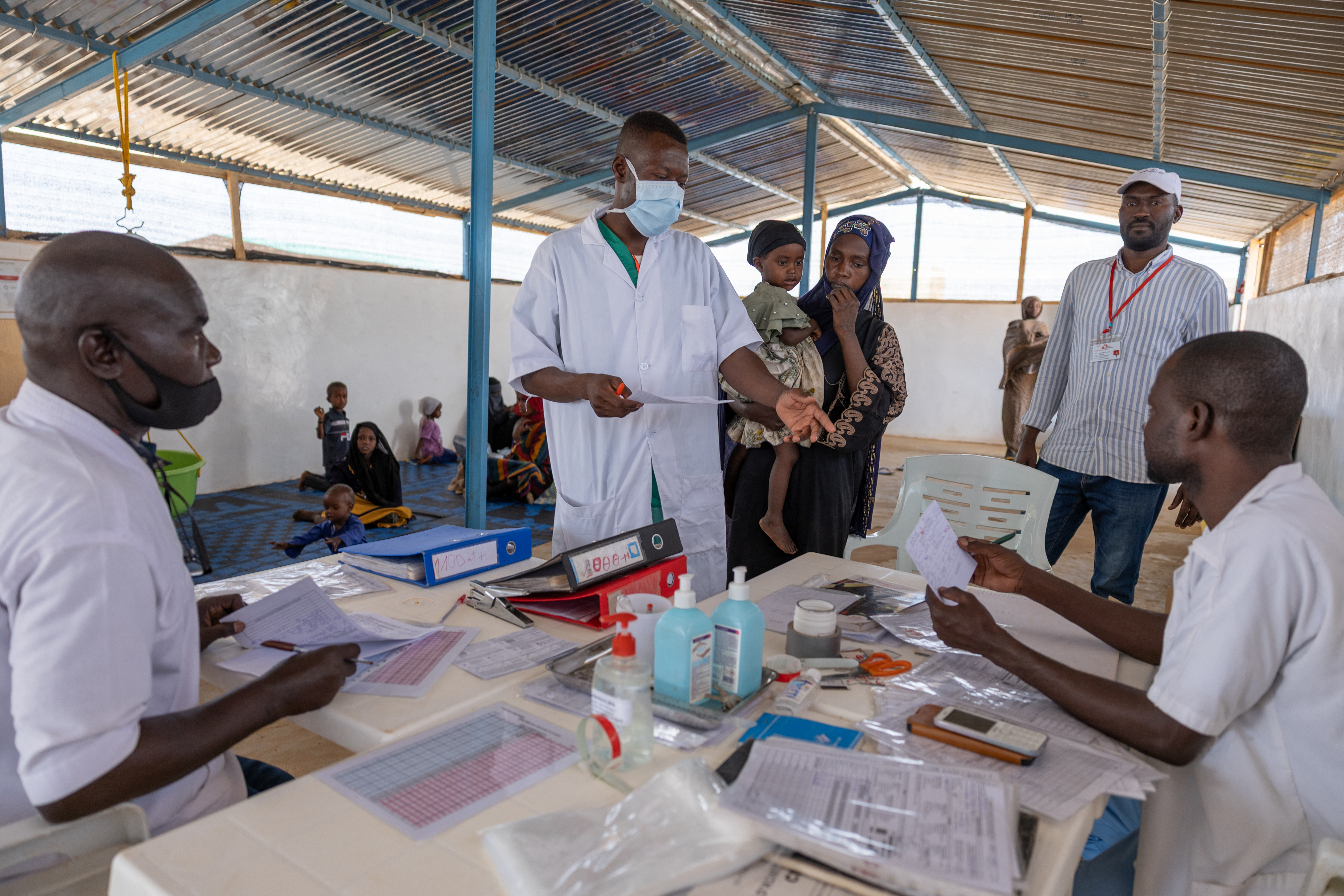 A nurse treats a young refugee.