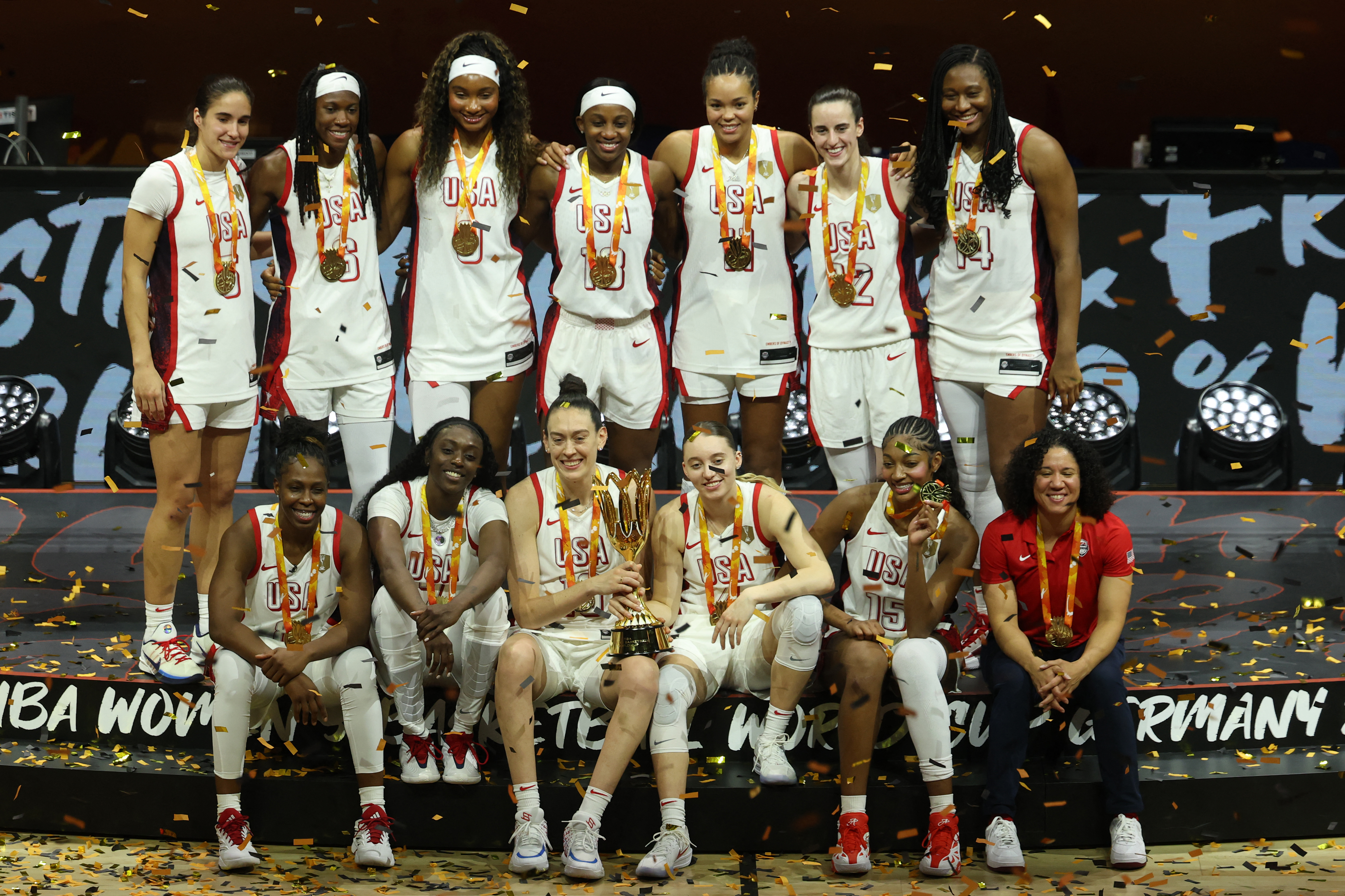 US' team poses with the world cup trophy during the medal ceremony following the 2026 FIBA Womens Basketball World Cup final game between the United States and France in Berlin on September 13, 2026. (Photo by Odd ANDERSEN / AFP)