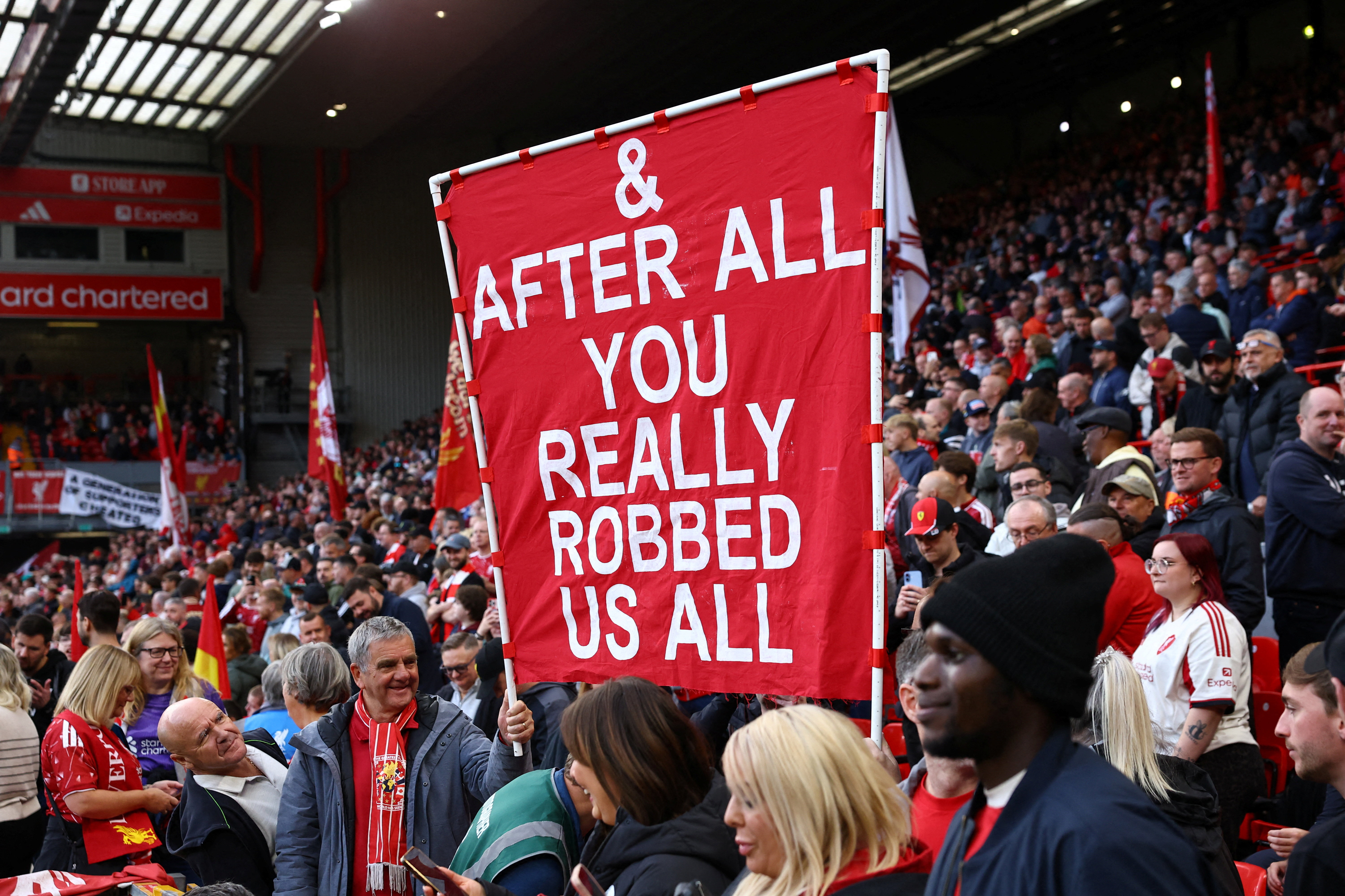 Soccer Football - Premier League - Liverpool v Manchester City - Anfield, Liverpool, Britain - October 11, 2026 Liverpool fans with a banner related to the Manchester City's Premier League charges inside the stadium before the match REUTERS/Phil Noble EDITORIAL USE ONLY. NO USE WITH UNAUTHORIZED AUDIO, VIDEO, DATA, FIXTURE LISTS, CLUB/LEAGUE LOGOS OR 'LIVE' SERVICES. ONLINE IN-MATCH USE LIMITED TO 120 IMAGES, NO VIDEO EMULATION. NO USE IN BETTING, GAMES OR SINGLE CLUB/LEAGUE/PLAYER PUBLICATIONS. PLEASE CONTACT YOUR ACCOUNT REPRESENTATIVE FOR FURTHER DETAILS.. TPX IMAGES OF THE DAY