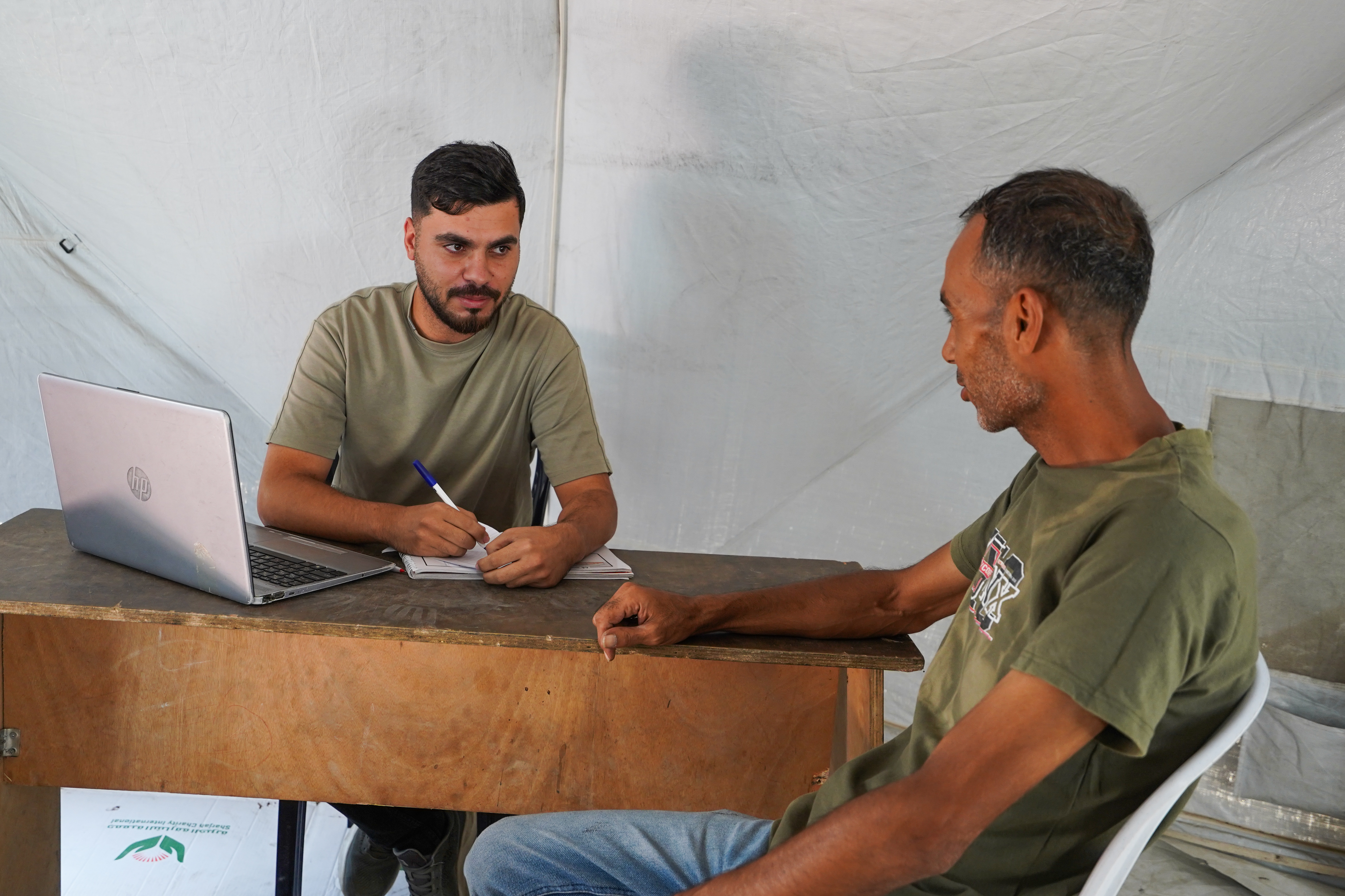 Accountant Mahmoud Shaheen continues his work and tries to maintain his source of income from inside a tent, replacing the office that was destroyed during the war October 6, 2026 [Iyad Al-Qatrawi/Al Jazeera]