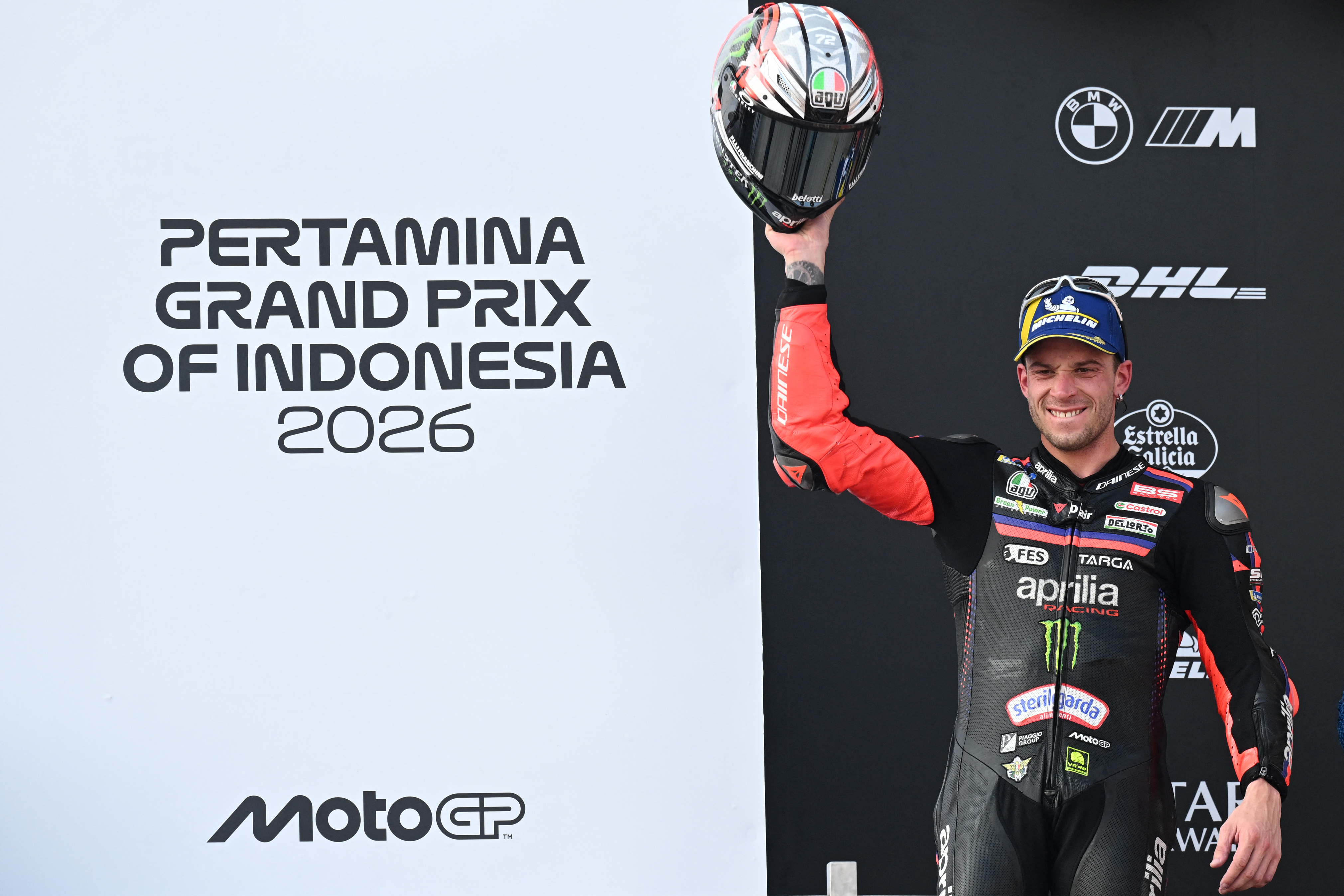 Aprilia Racing rider Marco Bezzecchi of Italy celebrates on the podium after winning the MotoGP Indonesian Grand Prix at the Mandalika International Circuit in Mandalika on October 11, 2026. (Photo by SONNY TUMBELAKA / AFP)