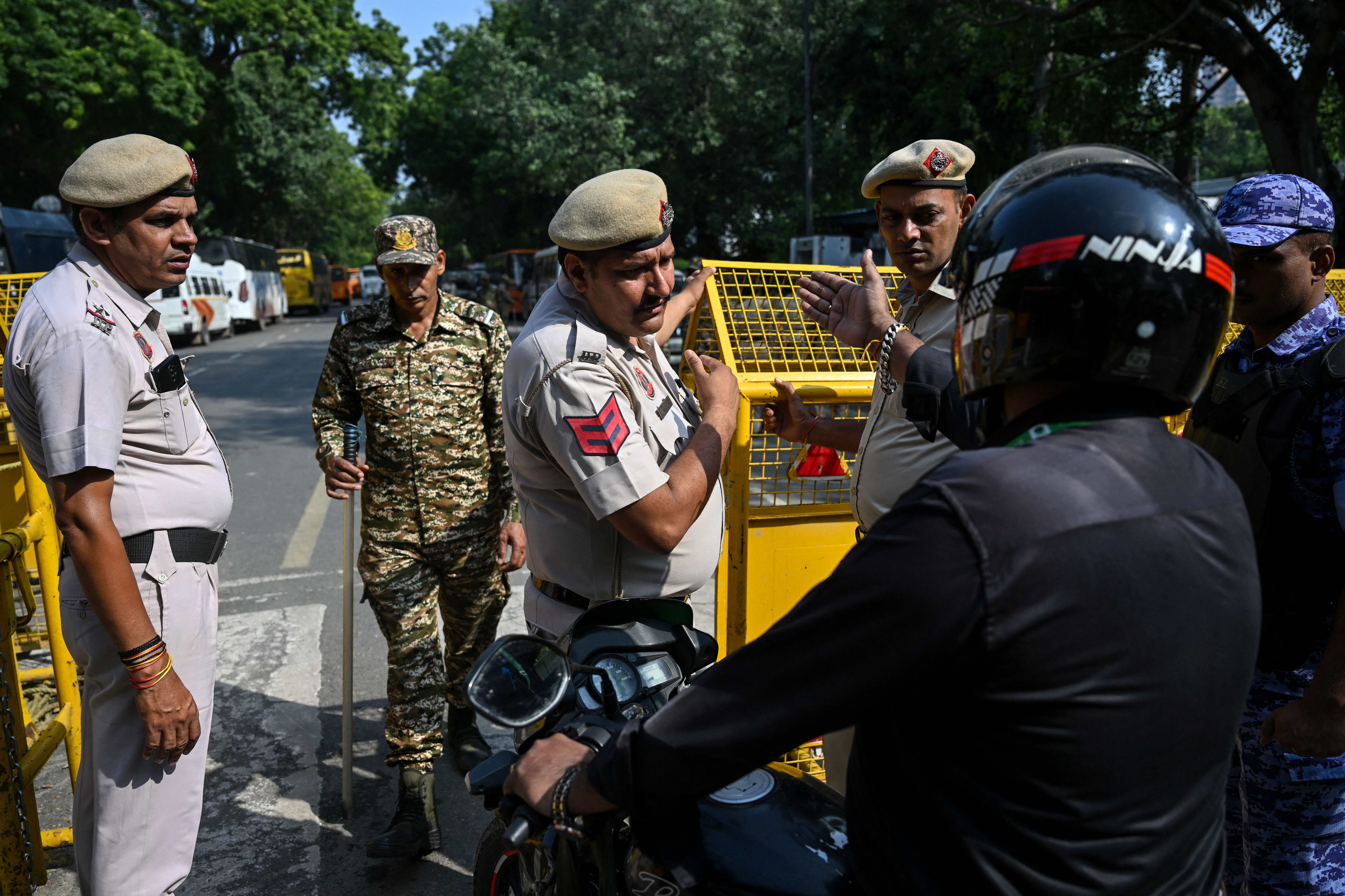 Police personnel inspect vehicles.