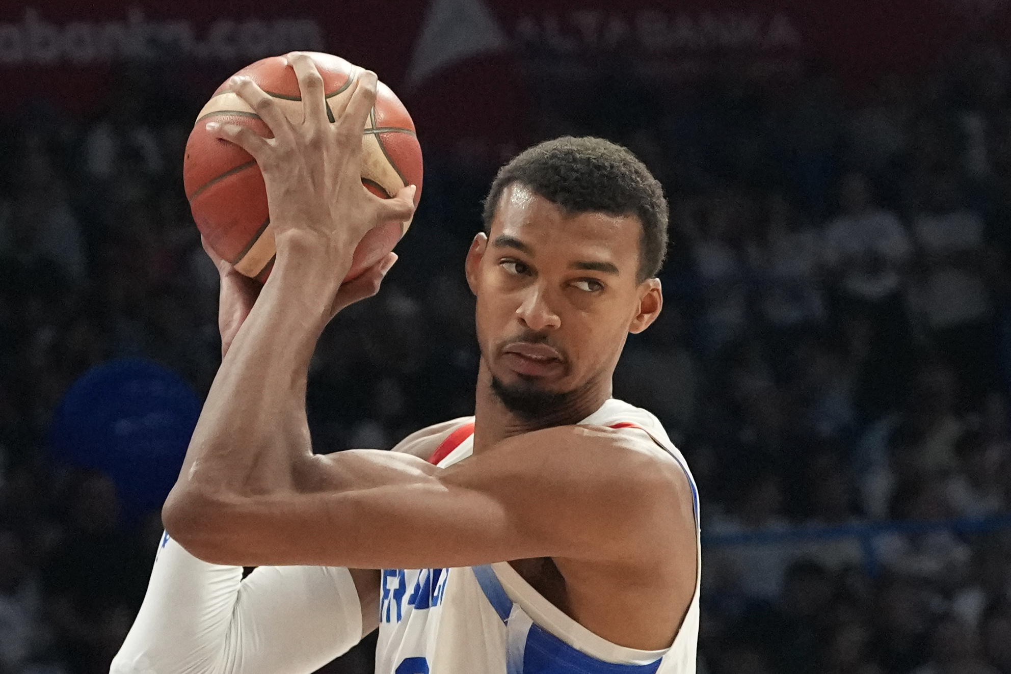 France's Victor Wembanyama holds a basketball.