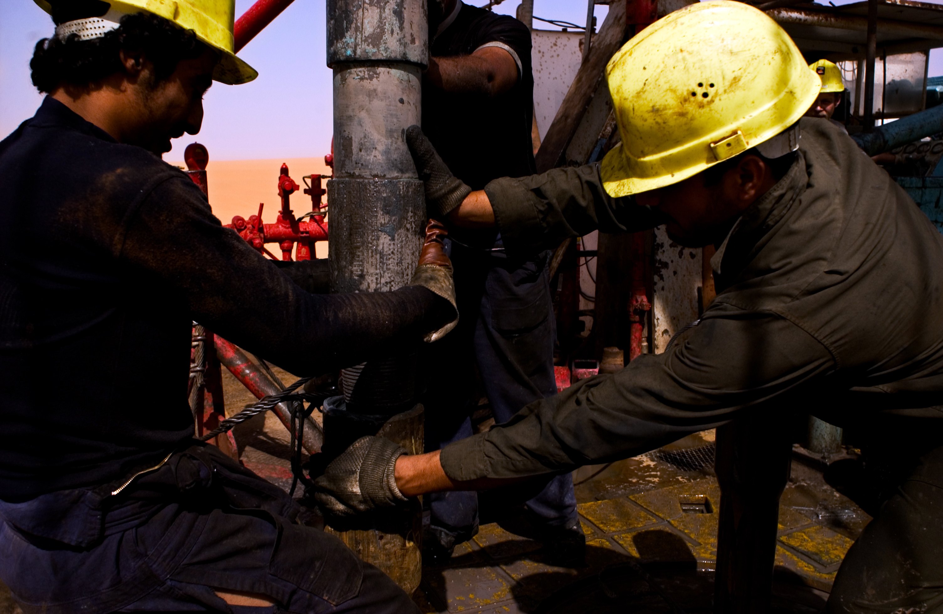 EL-SHARARA, LIBYA - JUNE 5: A Repsol Oil Operations oil drilling rig pounds into the desert searching through thousands of feet for and oil reserve on June 5, 2004 in El-Sharara, Libya. With the lifting of US sanctions earlier this year, American oil companies, eager to find other avenues for oil exploration have begun negotiating with the Libyan government to return to its vast oil fields. (Photo by Benjamin Lowy/Getty Images)