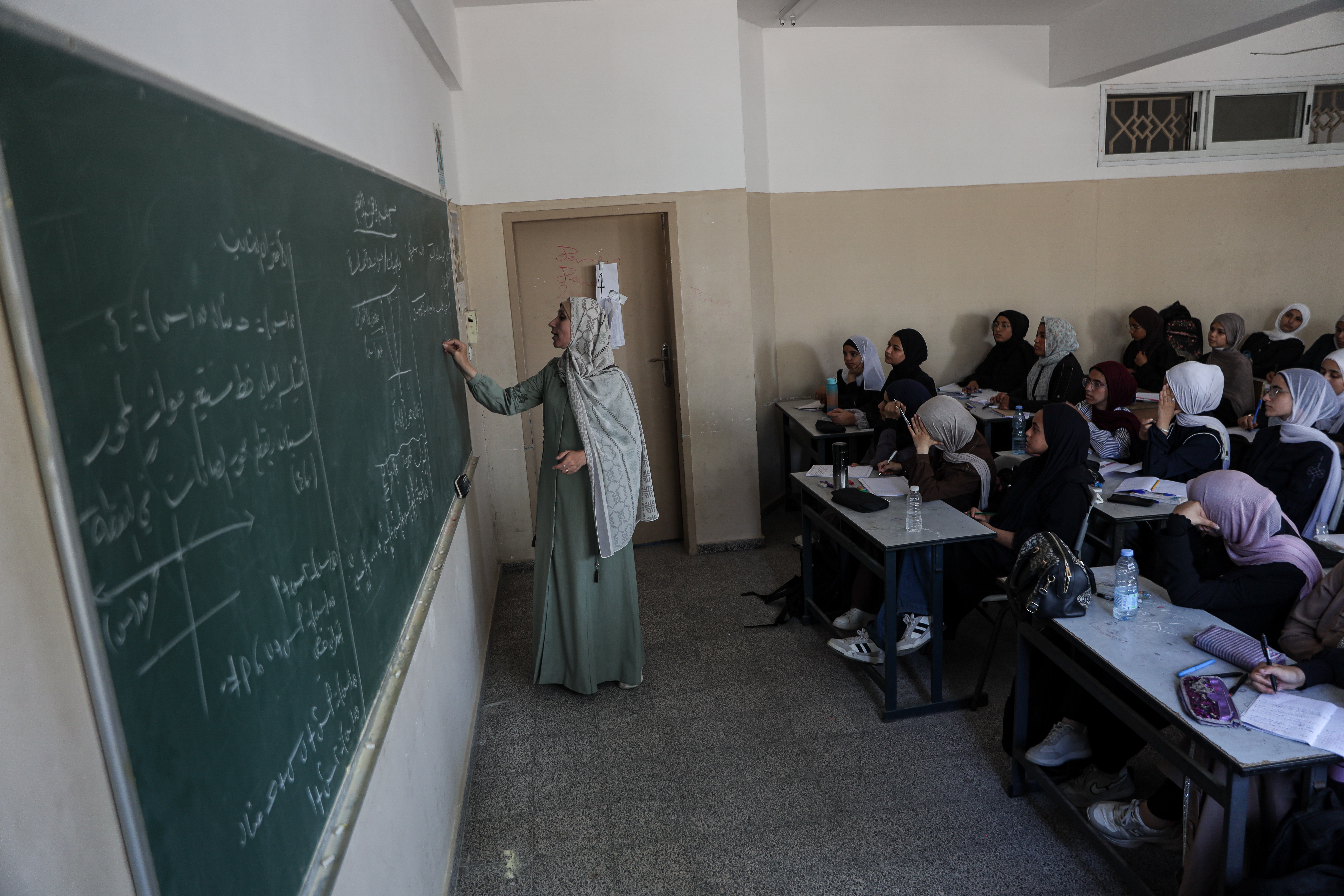 Maha Taha, 43, has taught mathematics at Muscat Secondary School for Girls for 20 years. In June 2023, she posed for a selfie with 15 of her pupils. Three years later, she still keeps the photograph on her phone