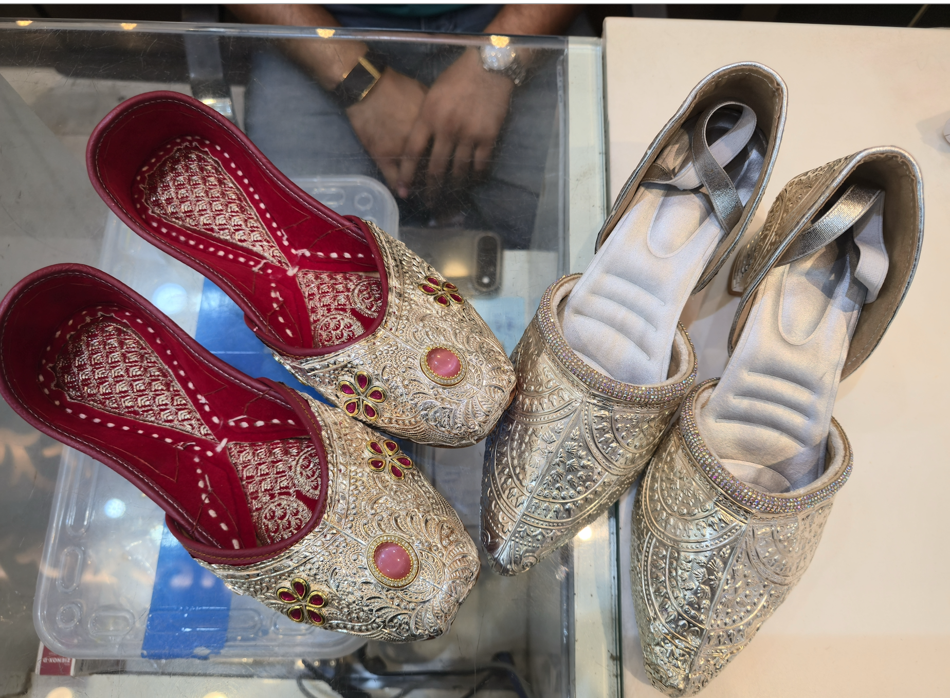 Two styles of silver nagra wedding shoes made by Jabbar Hussain, a fourth-generation craftsman and shopkeeper in Lucknow, India [Aatif Ammad/Al Jazeera]
