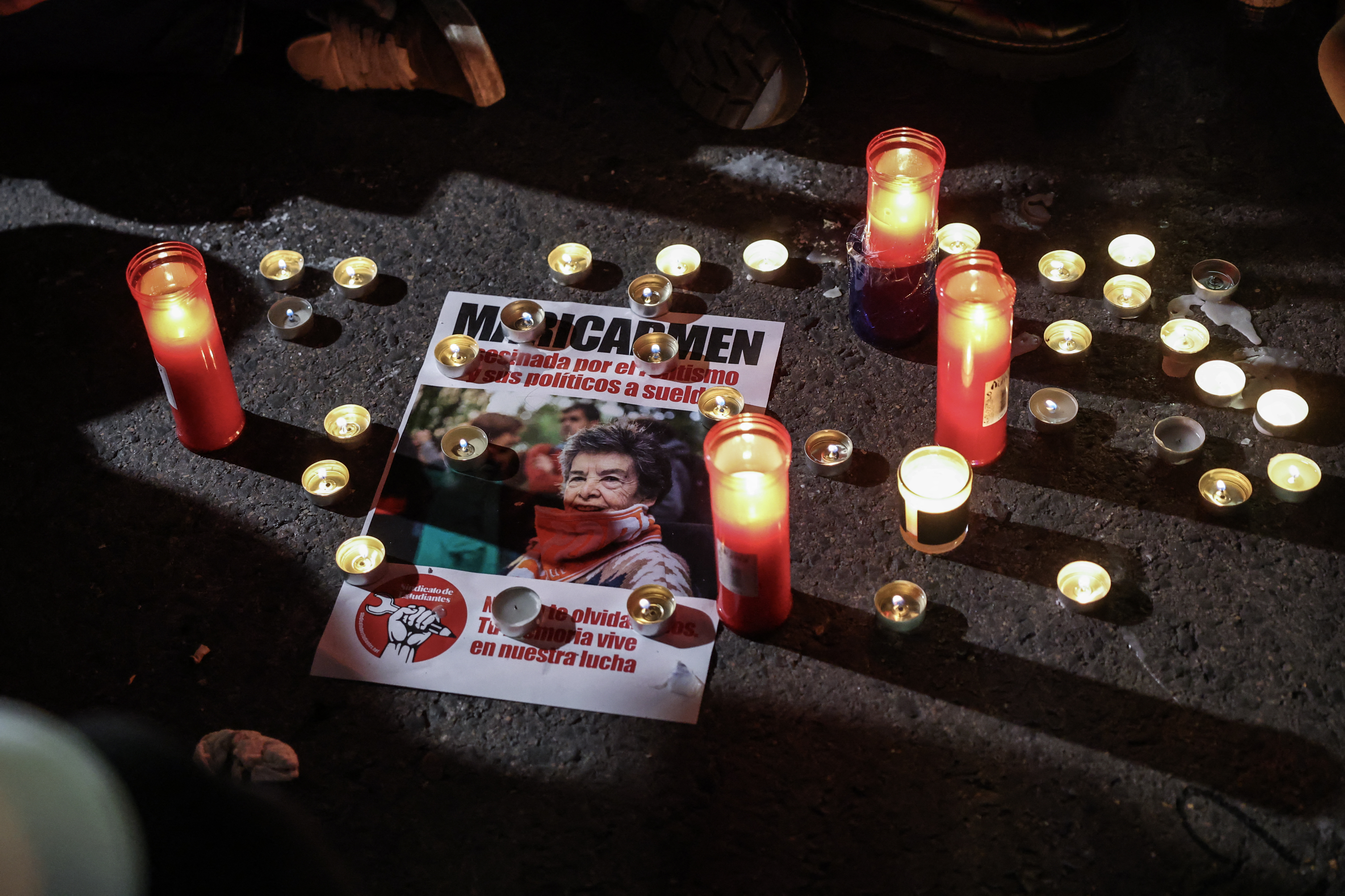 A flyer with an image of Maricarmen Abascal, the 87-year-old pensioner whose eviction triggered nationwide protests over Spain's chronic housing crisis and a political debate that culminated in early elections, is seen at an impromptu protest vigil after she died in hospital in Madrid on October 7, 2026.