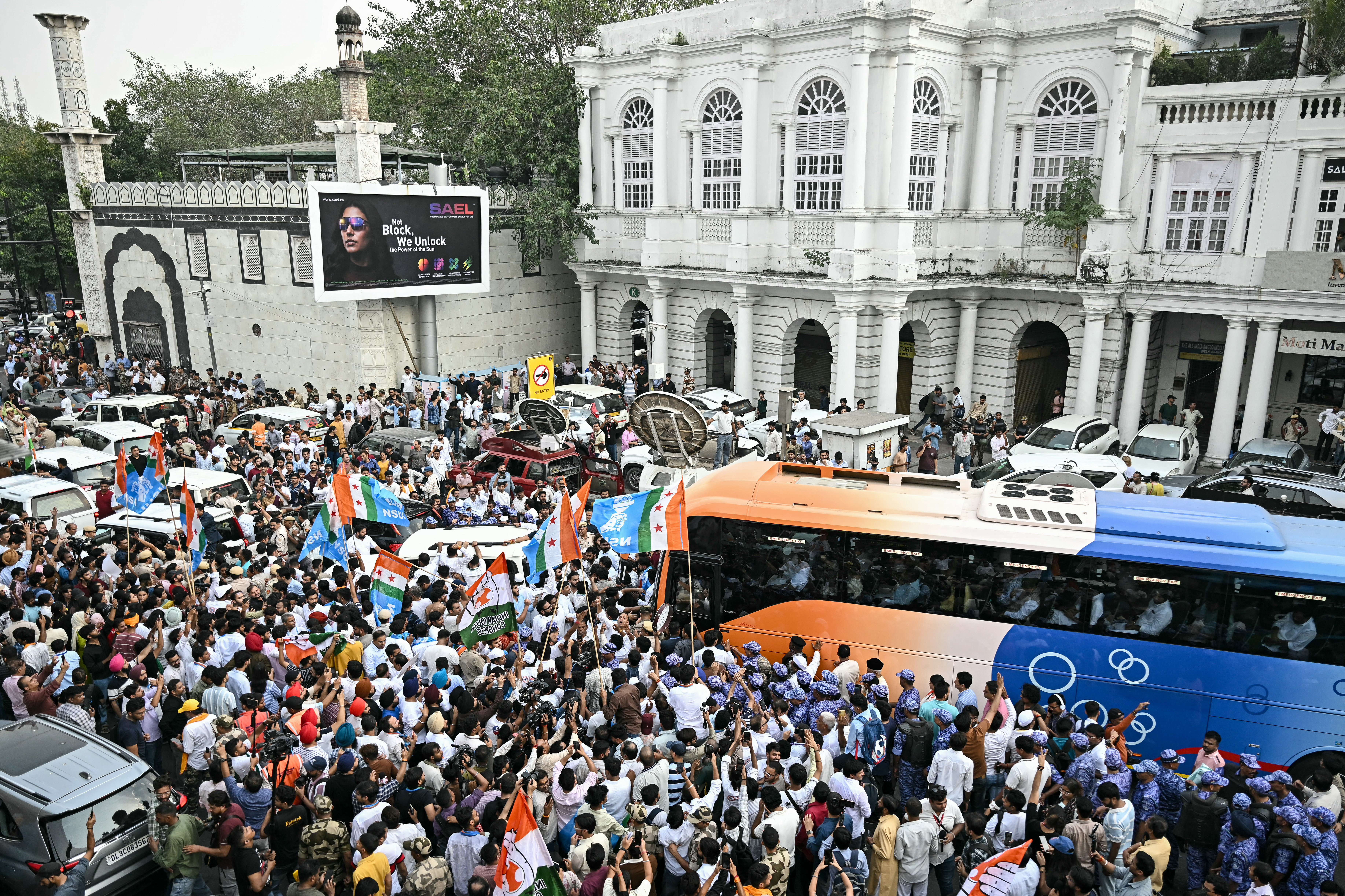Congress party supporters gather as India's opposition alliance, the INDIA bloc (Indian National Developmental Inclusive Alliance), leaders leave in a bus to participate in a protest in New Delhi on October 8, 2026 against the country's Chief Election Commissioner Gyanesh Kumar calling for his resignation over alleged irregularities in the Special Intensive Revision (SIR) of electoral rolls.