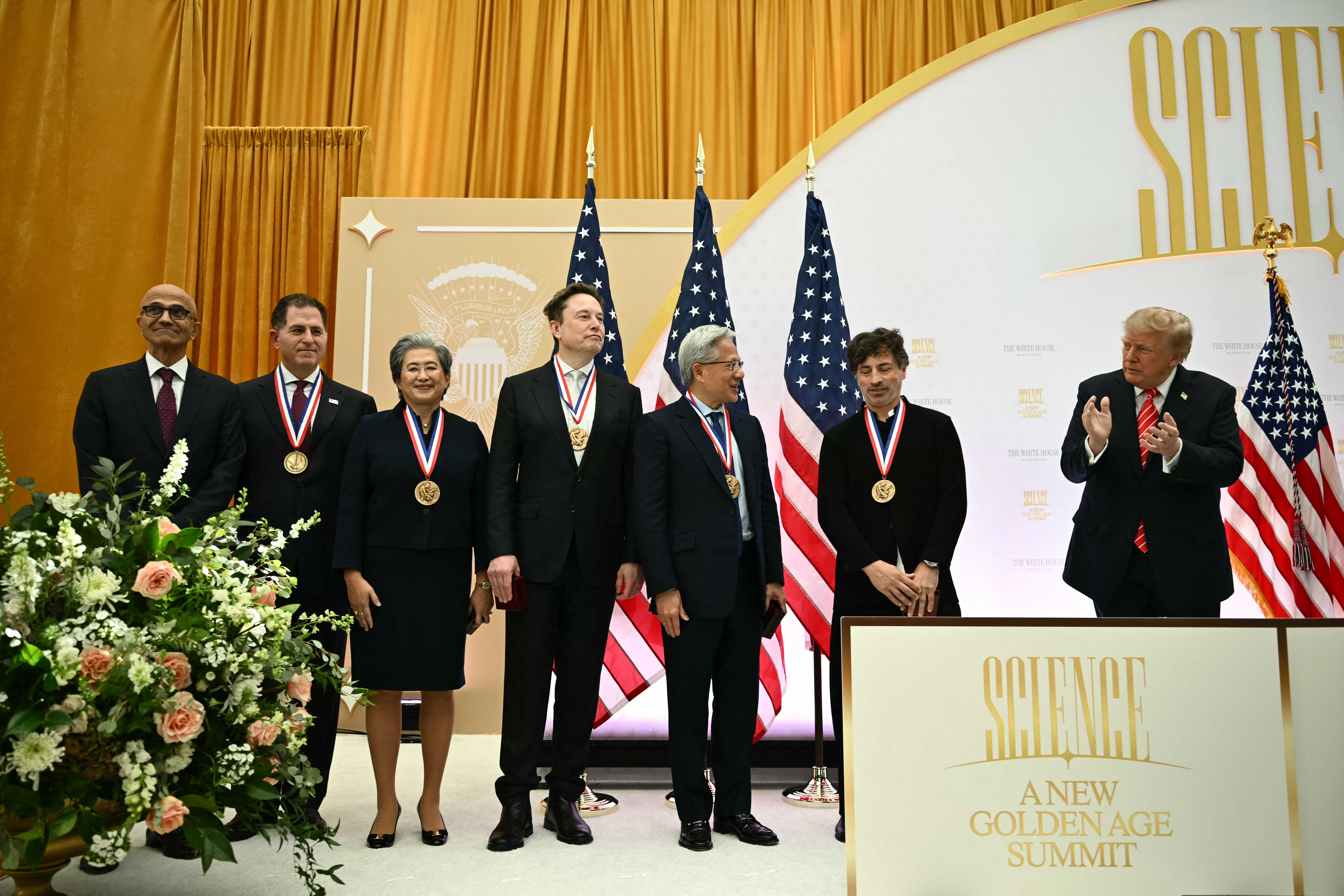 (From L) Microsoft CEO Satya Nadella, Dell Techologies CEO Michael Dell, AMD CEO Lisa Su, SpaceX CEO Elon Musk, Nvidia CEO Jensen Huang and entrepreneur Sergey Brin are applauded by US President Donald Trump during the "Golden Age of American Innovation Summit" at the Institute of Peace in Washington, DC, on October 8, 2026. (Photo by Kent NISHIMURA / AFP)