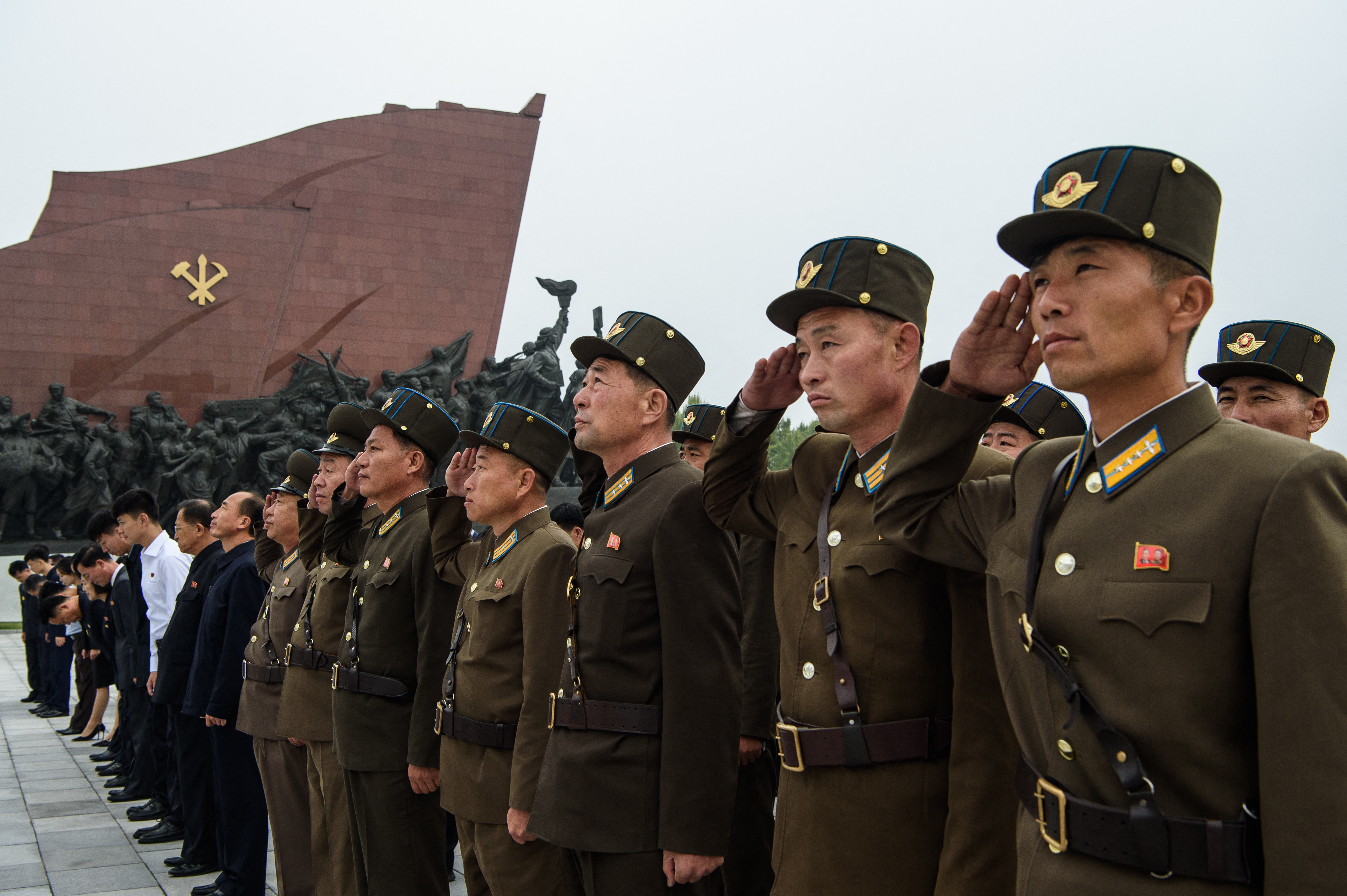 Korean People's Army service personnel salute the statues of late North Korean leaders Kim Il Sung and Kim Jong Il to pay their respects on the occasion of the 81st founding anniversary of the Workers' Party of Korea at Mansu Hill in Pyongyang on October 10, 2026. (Photo by KIM Won Jin / AFP)