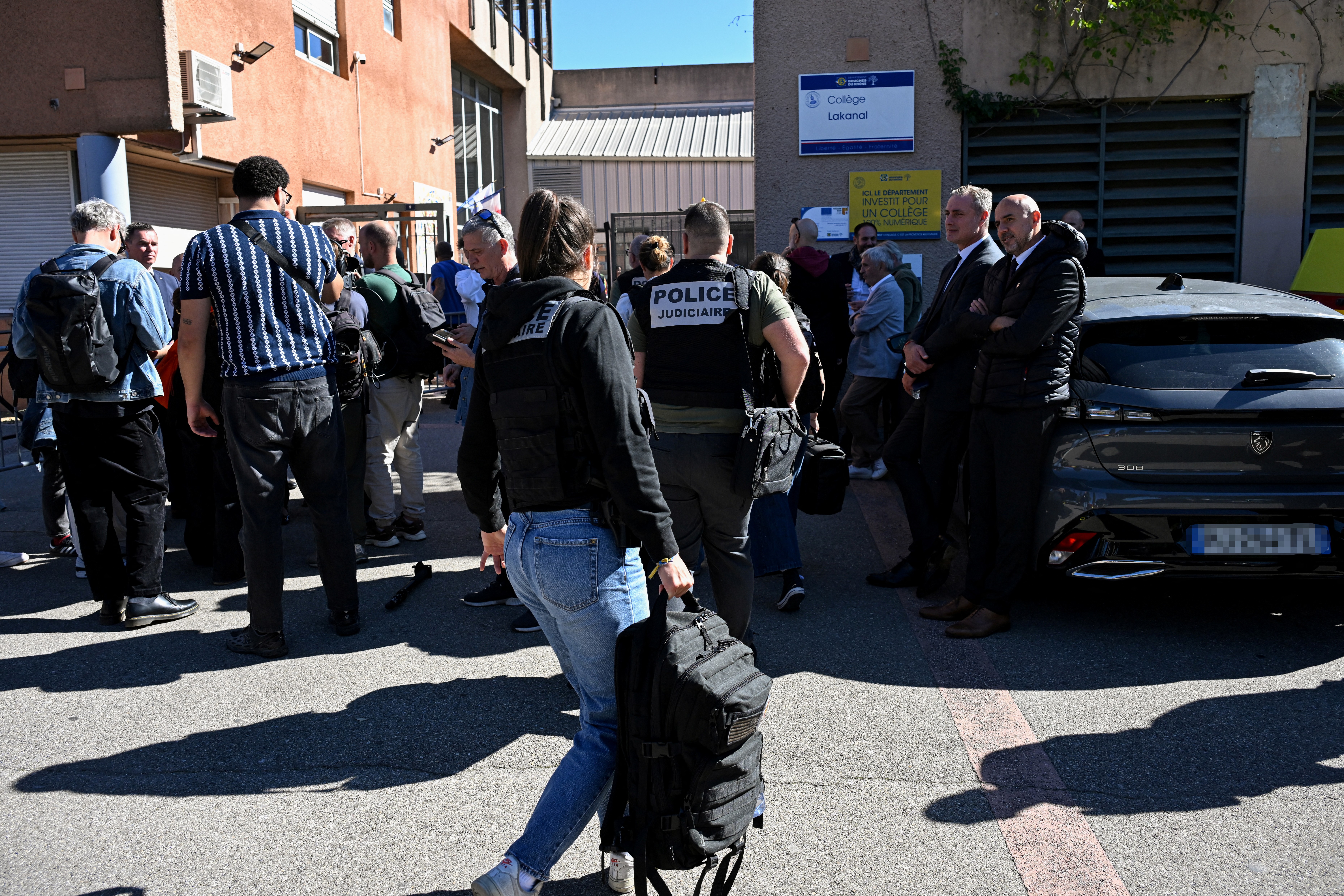 French judicial police officers arrive at the Joseph-Lakanal middle school after a headmaster was injured by a hunting rifle shot and a teenager was arrested in Aubagne, southern France on October 12, 2026.