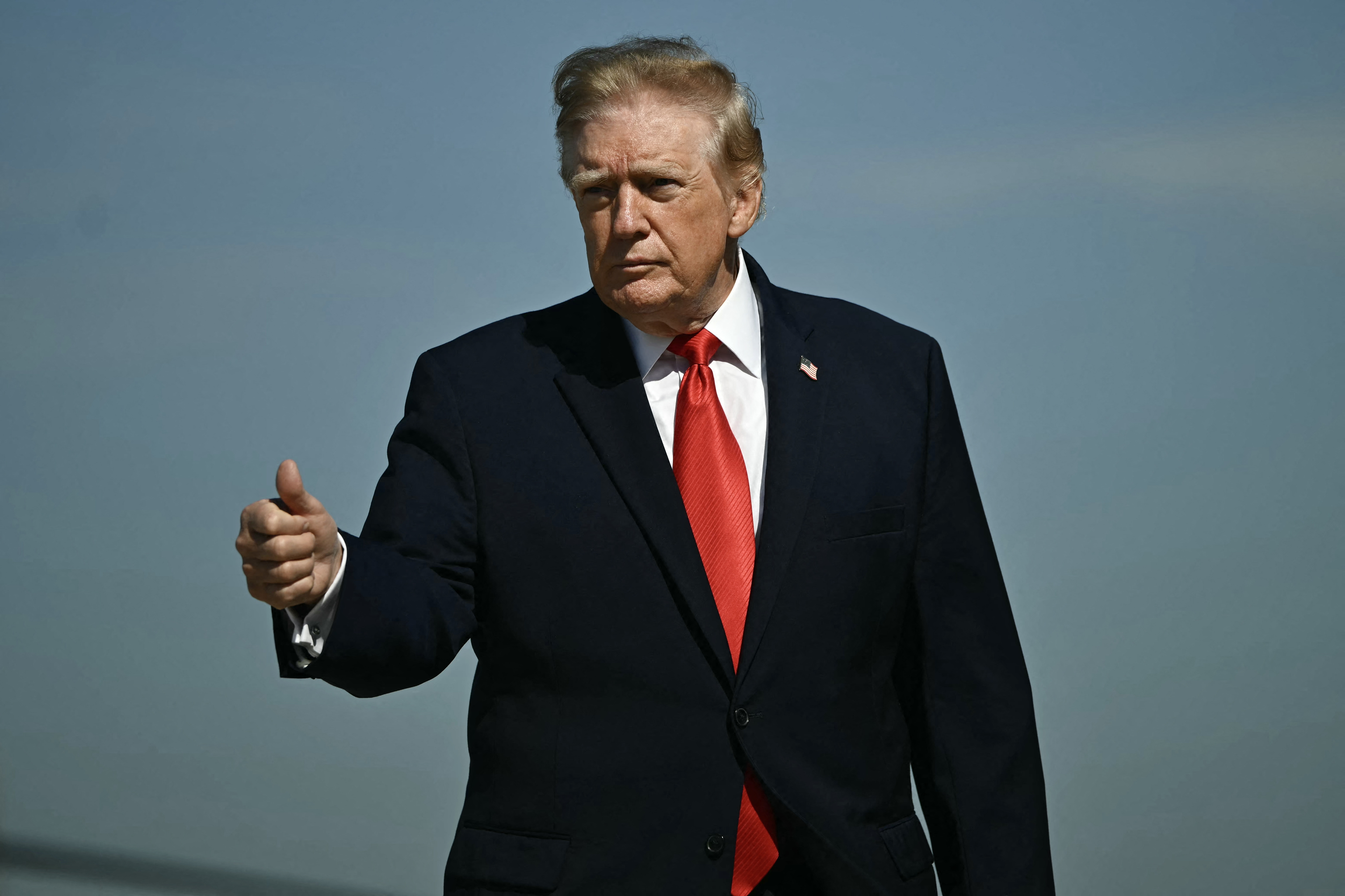 US President Donald Trump gestures as he walks to board Air Force One at Joint Base Andrews, Maryland on October 13, 2026.