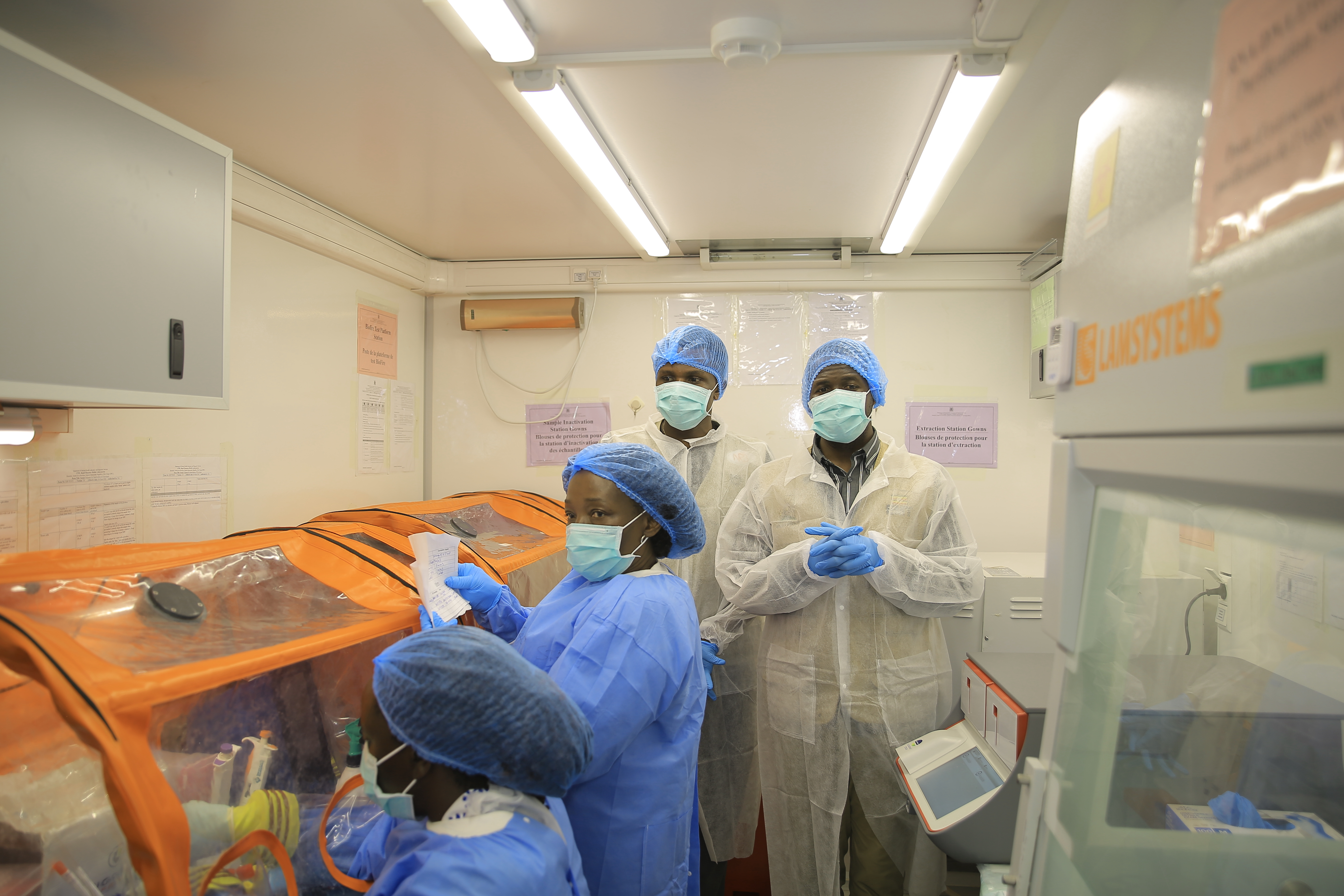 Medical workers work inside a mobile lab set up to test rapidly for Ebola virus in Butembo, Congo, Wednesday, Sept. 30, 2026. (AP Photo/Sebastien Kitsa Musayi)