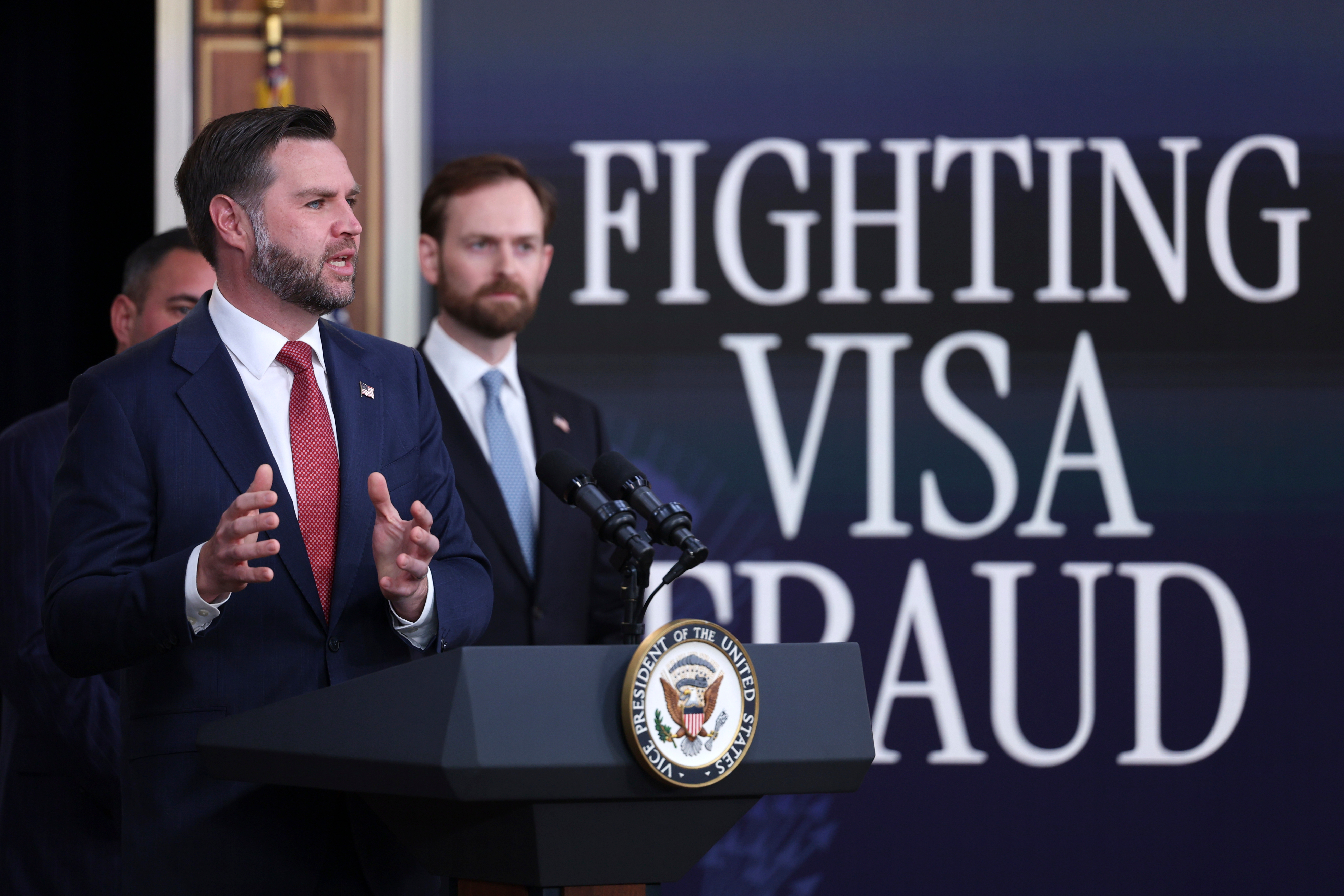 Vice President JD Vance speaks as Andrew Ferguson, Chairman of the Federal Trade Commission, listens during a news conference on the Fraud Task Force inside the Eisenhower Executive Office Building on the White House campus, Thursday, Oct. 8, 2026, in Washington. (AP Photo/Tom Brenner)