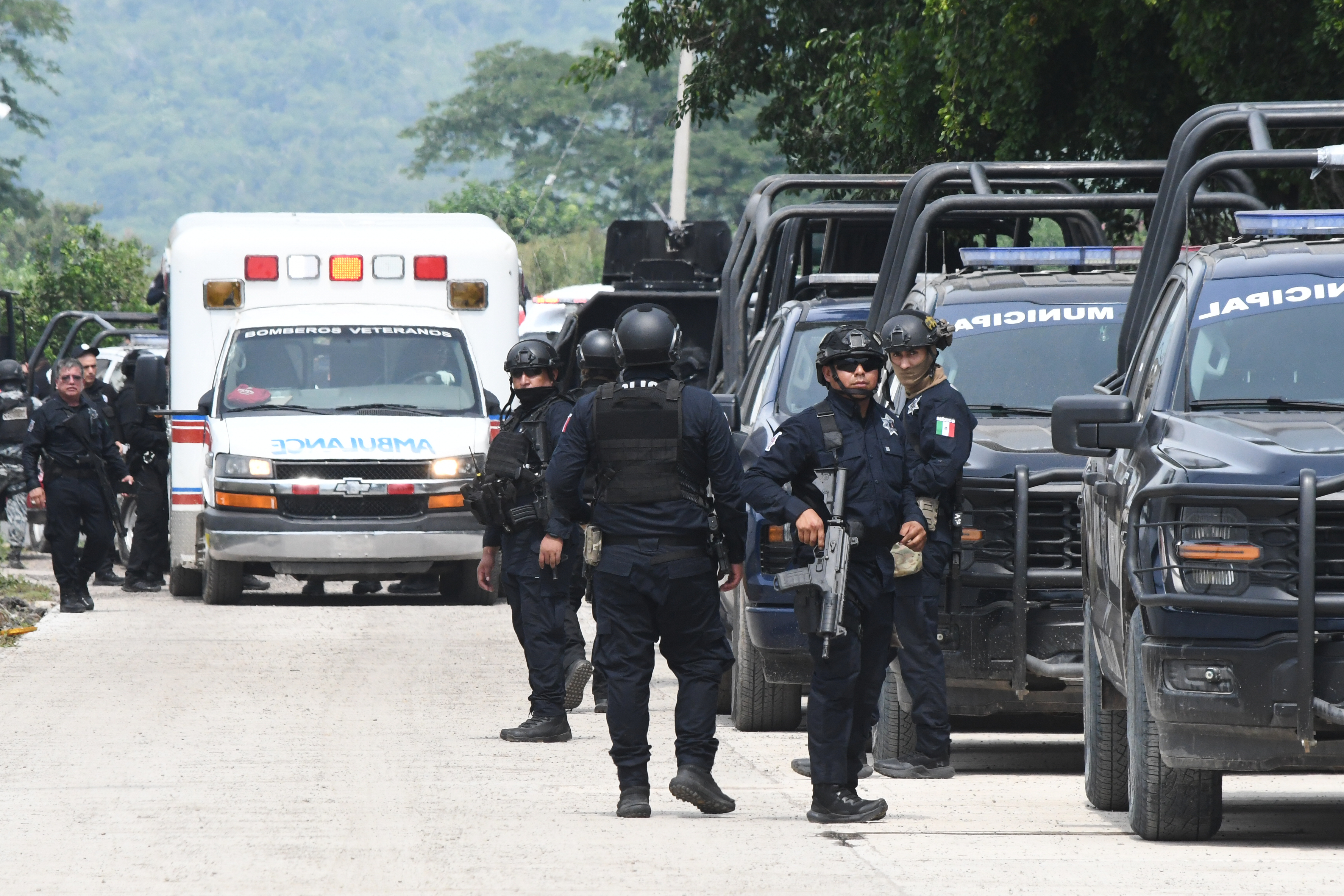 Police officers surrounded by vehicles.