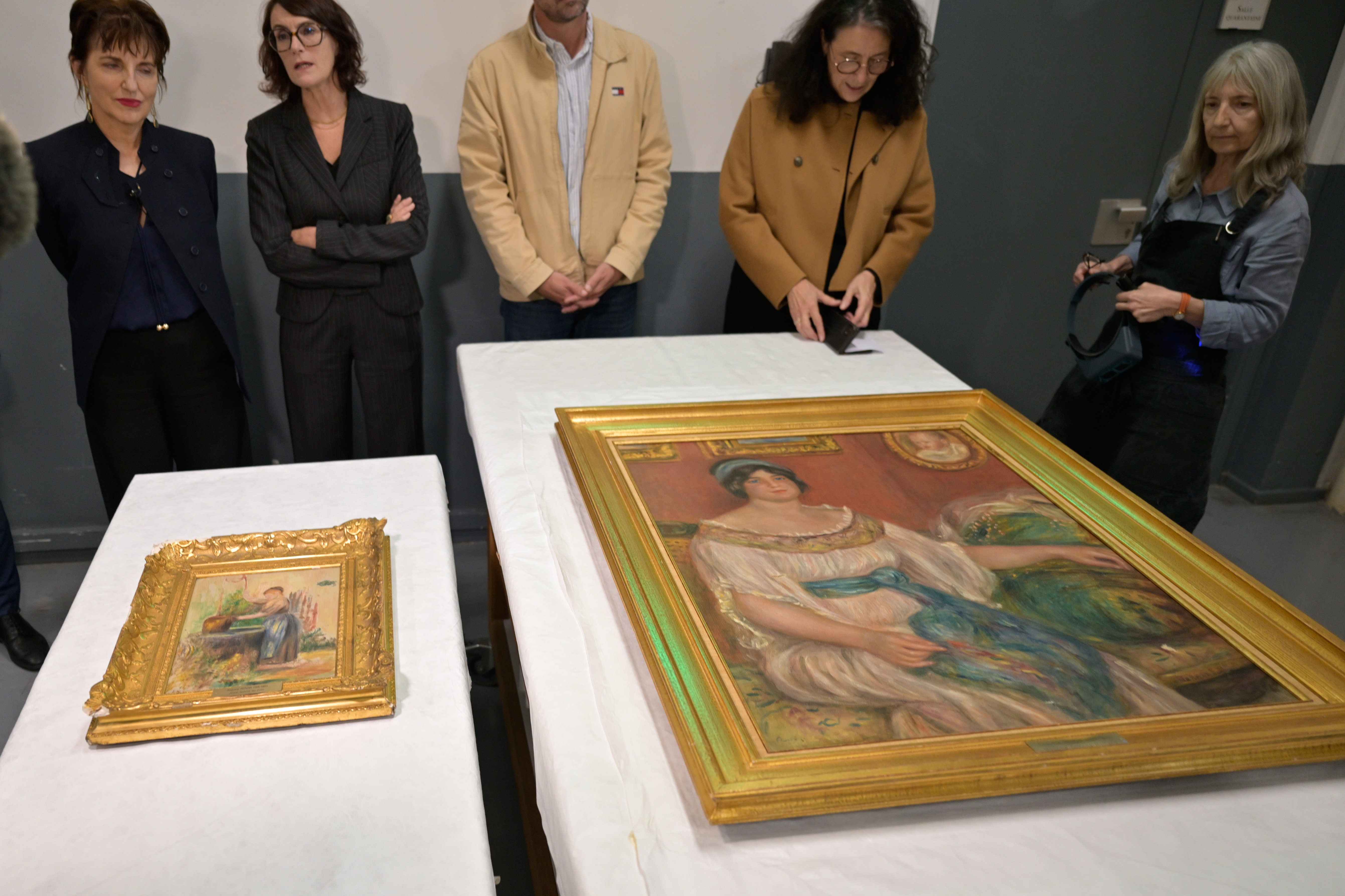 Recovered paintings "Portrait of Madame Colonna Romano", right, and "Young Woman at the Well," stolen from the Renoir Museum in Cagnes-sur-Mer are on display at the Interdisciplinary Centre for the Conservation and Restoration of Heritage in Marseille, France, Monday Oct. 12, 2026. (AP Photo/Philippe Magoni)