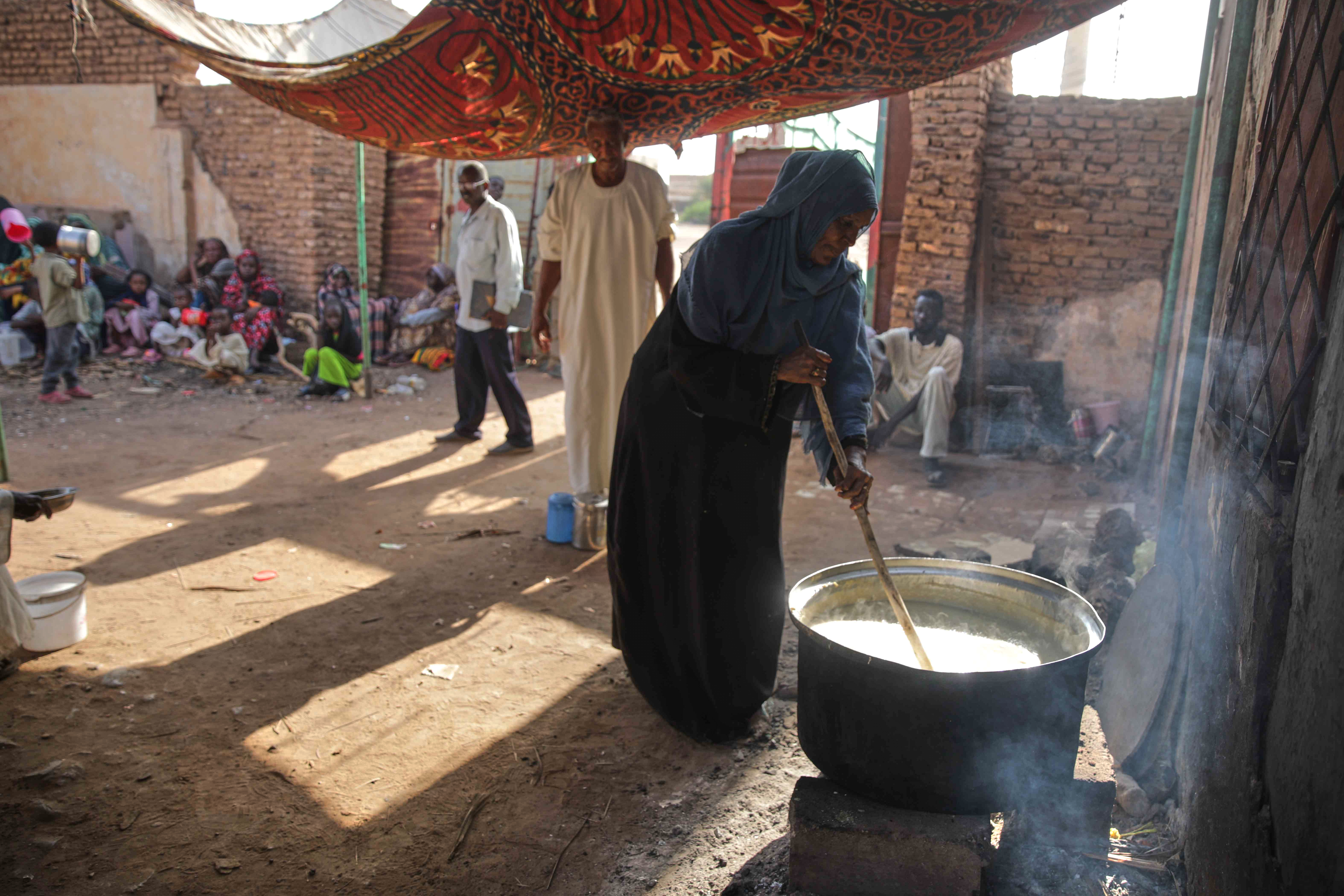 A woman prepares food to be distributed to people in need in Khartoum, Sudan, Wednesday, Sept. 23, 2026. (AP Photo/Marwan Ali)